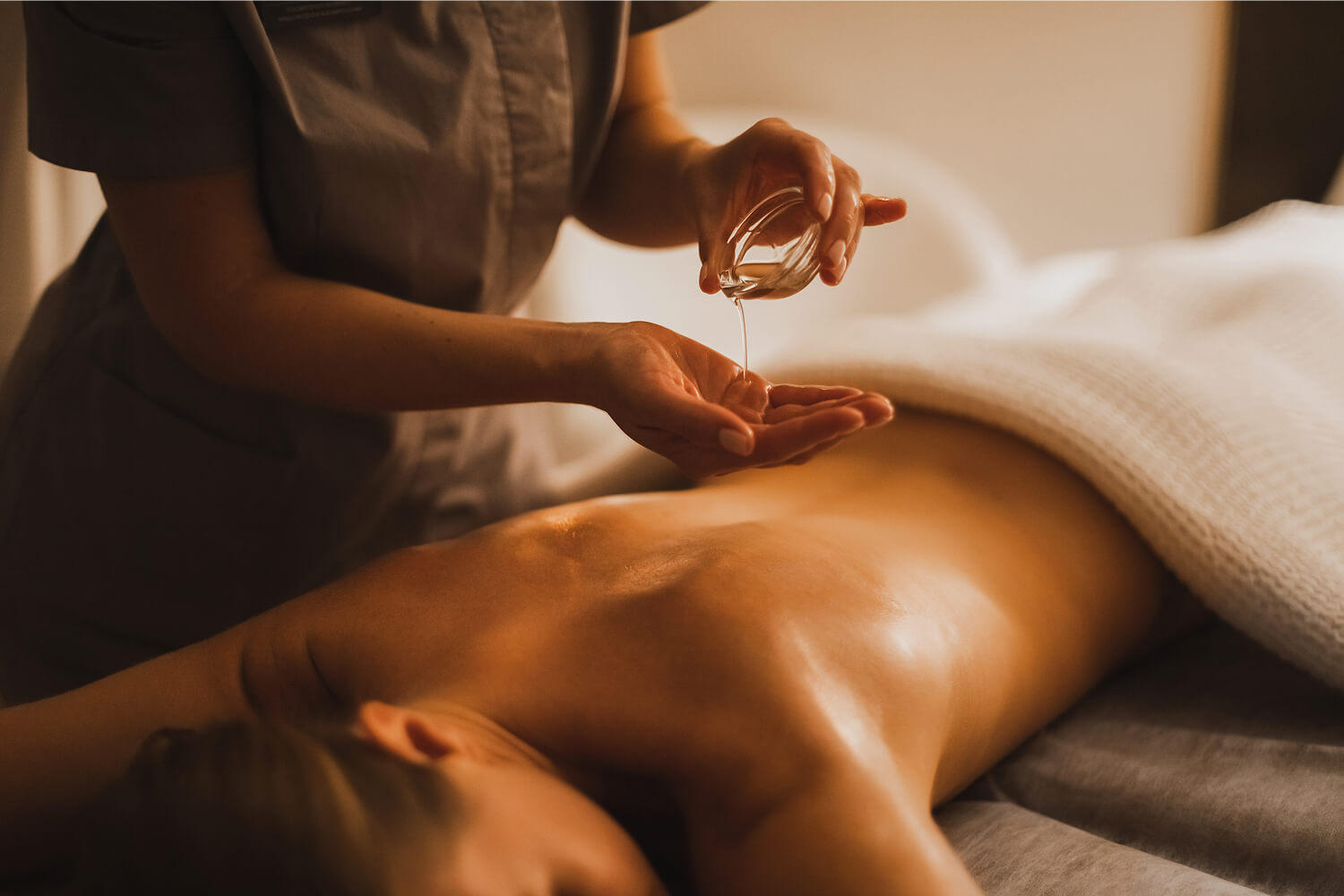 A woman getting a hot oil massage