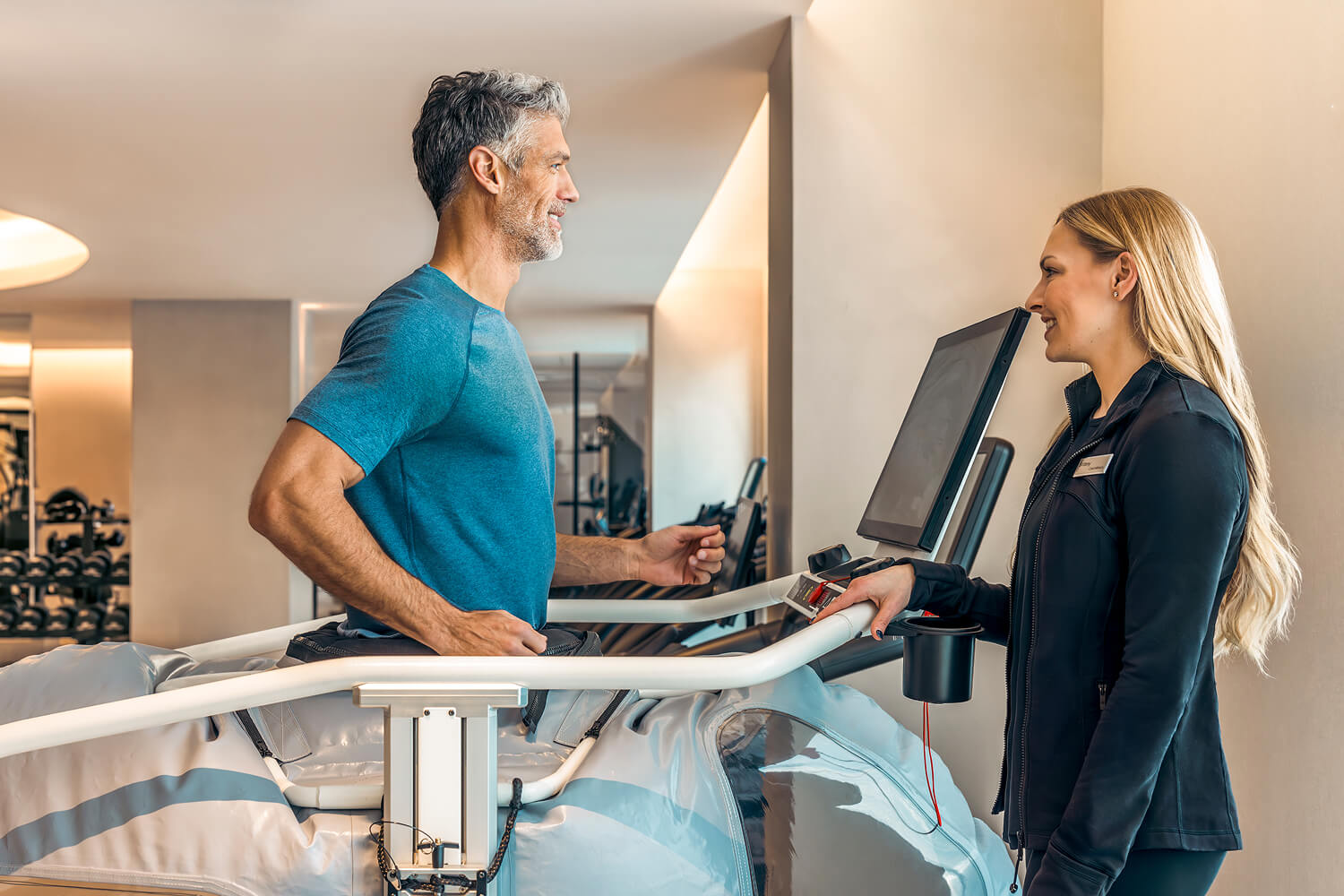 A man on a treadmill with a performance scientist