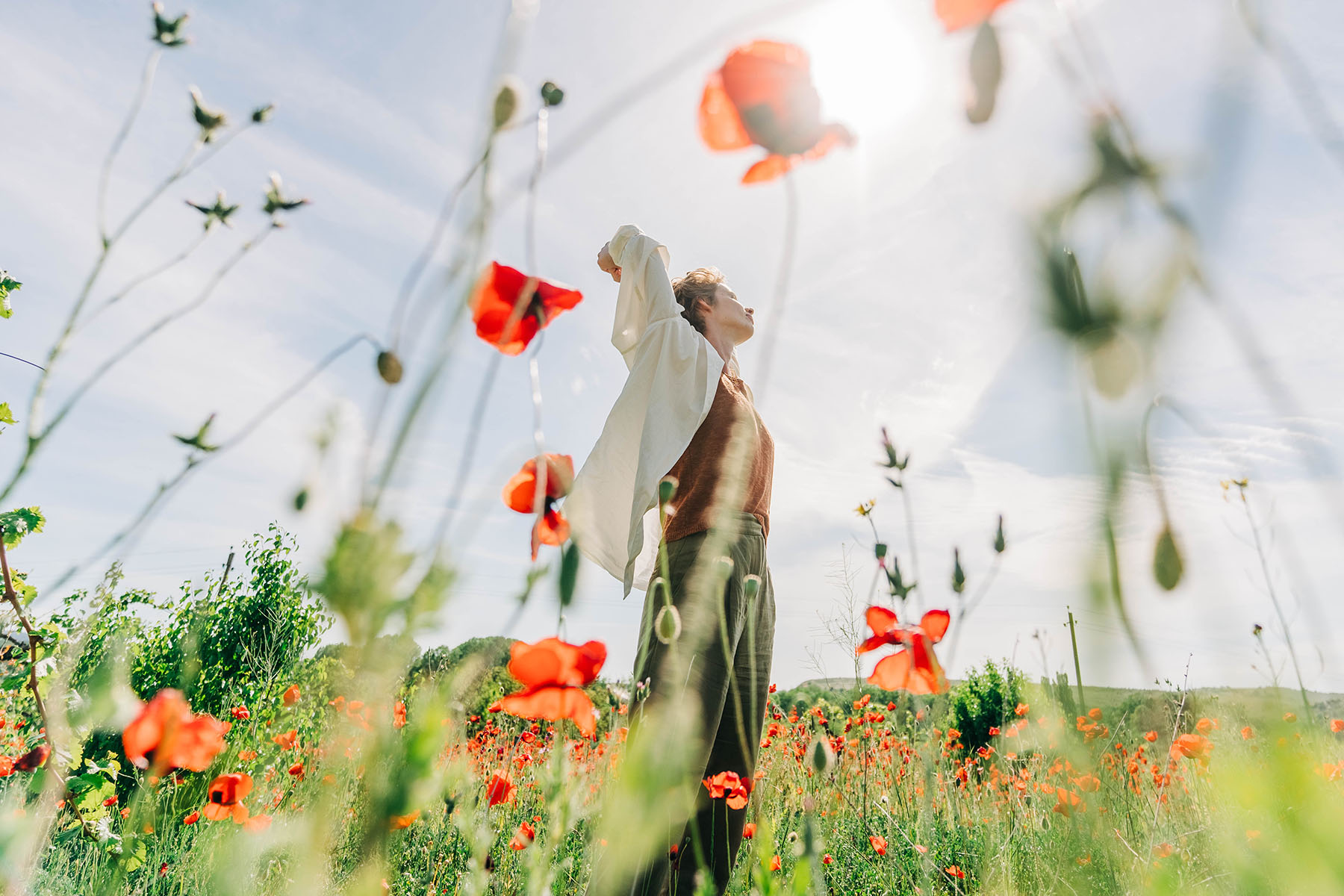 a woman standing in a field of flowers