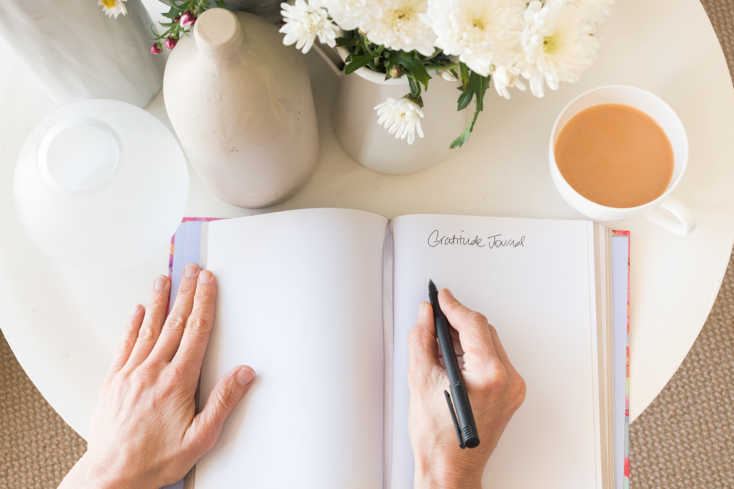 a person writing in a gratitude journal