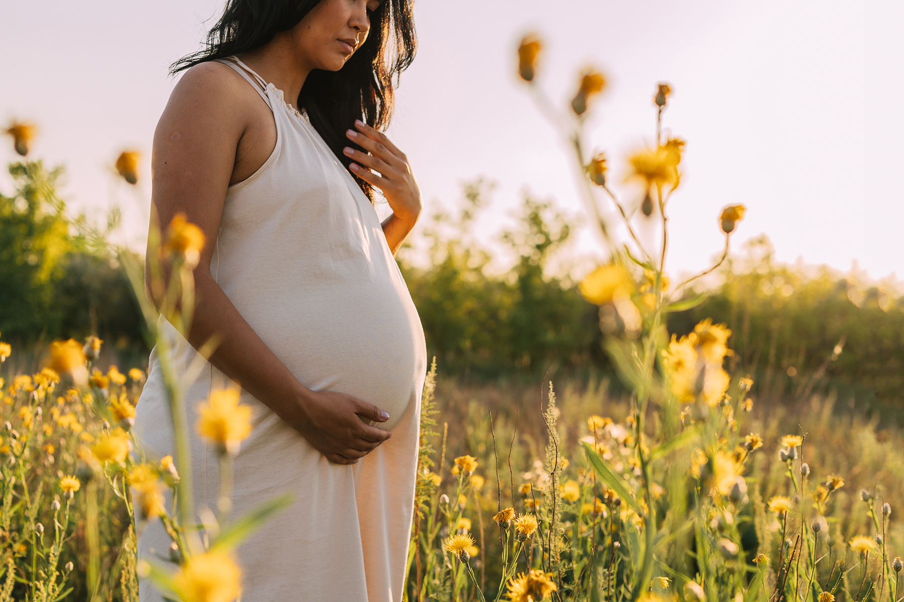 a pregnant woman in a field of flowers