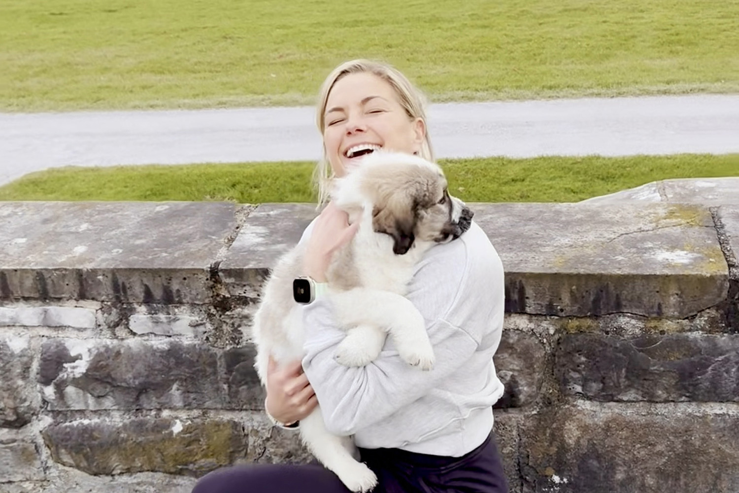 Liz Plosser snuggling a puppy 