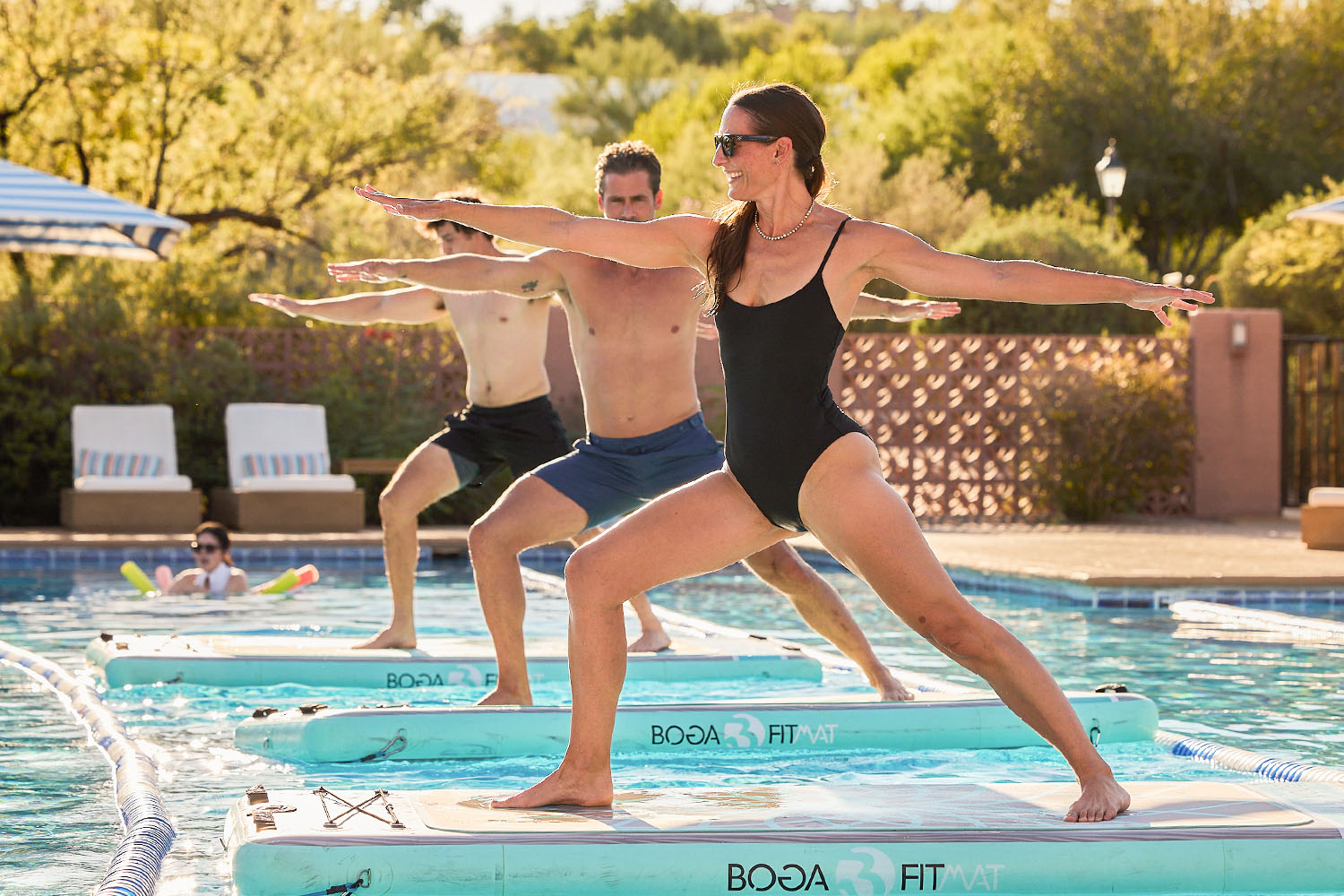a group of people doing bogafit yoga on water