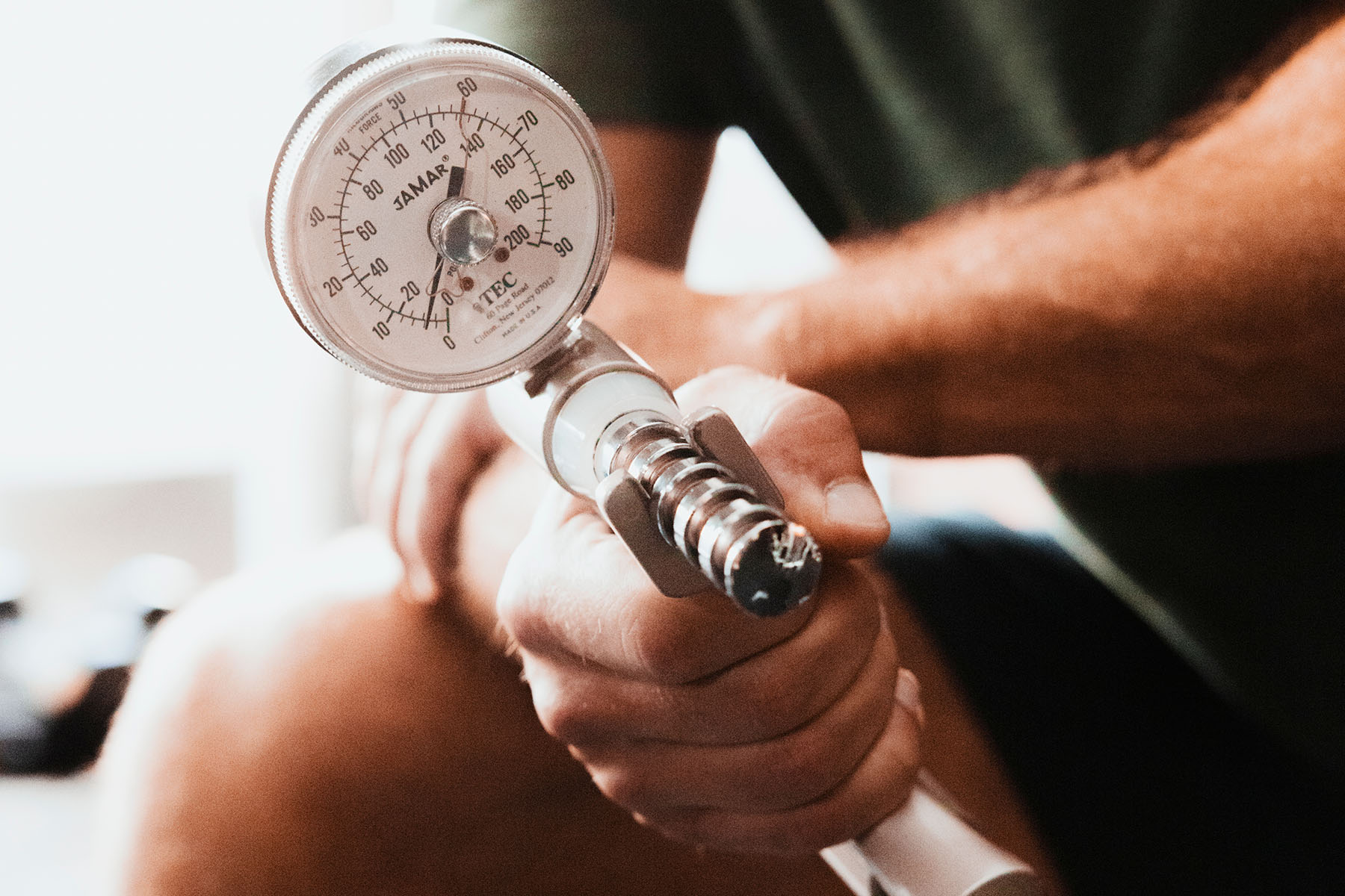 a man testing his grip strength on a machine