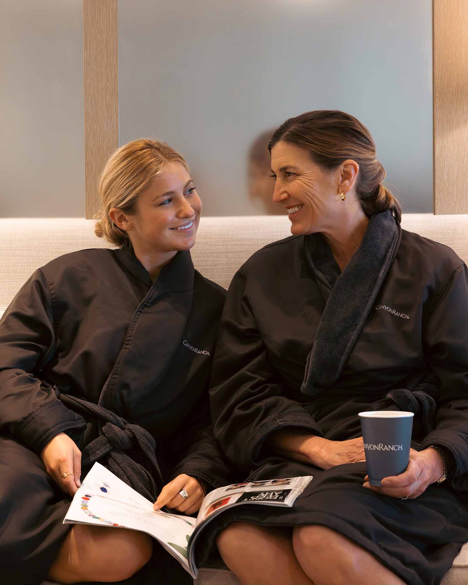 Mother and Daughter Laughing and Relaxing Together at the Relaxation Lounge