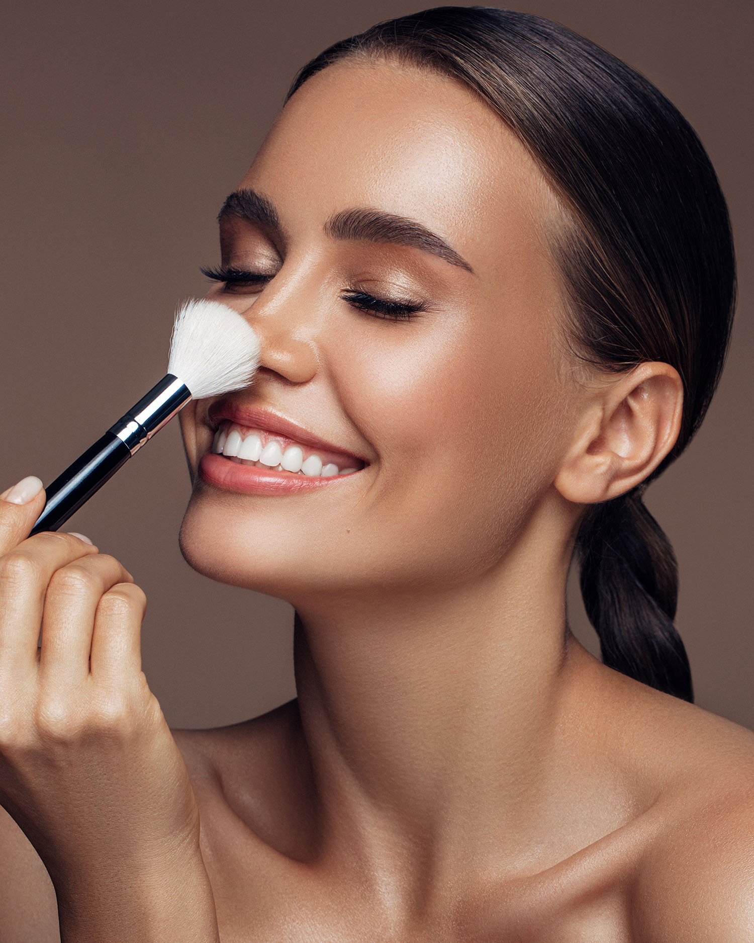 A woman putting on makeup