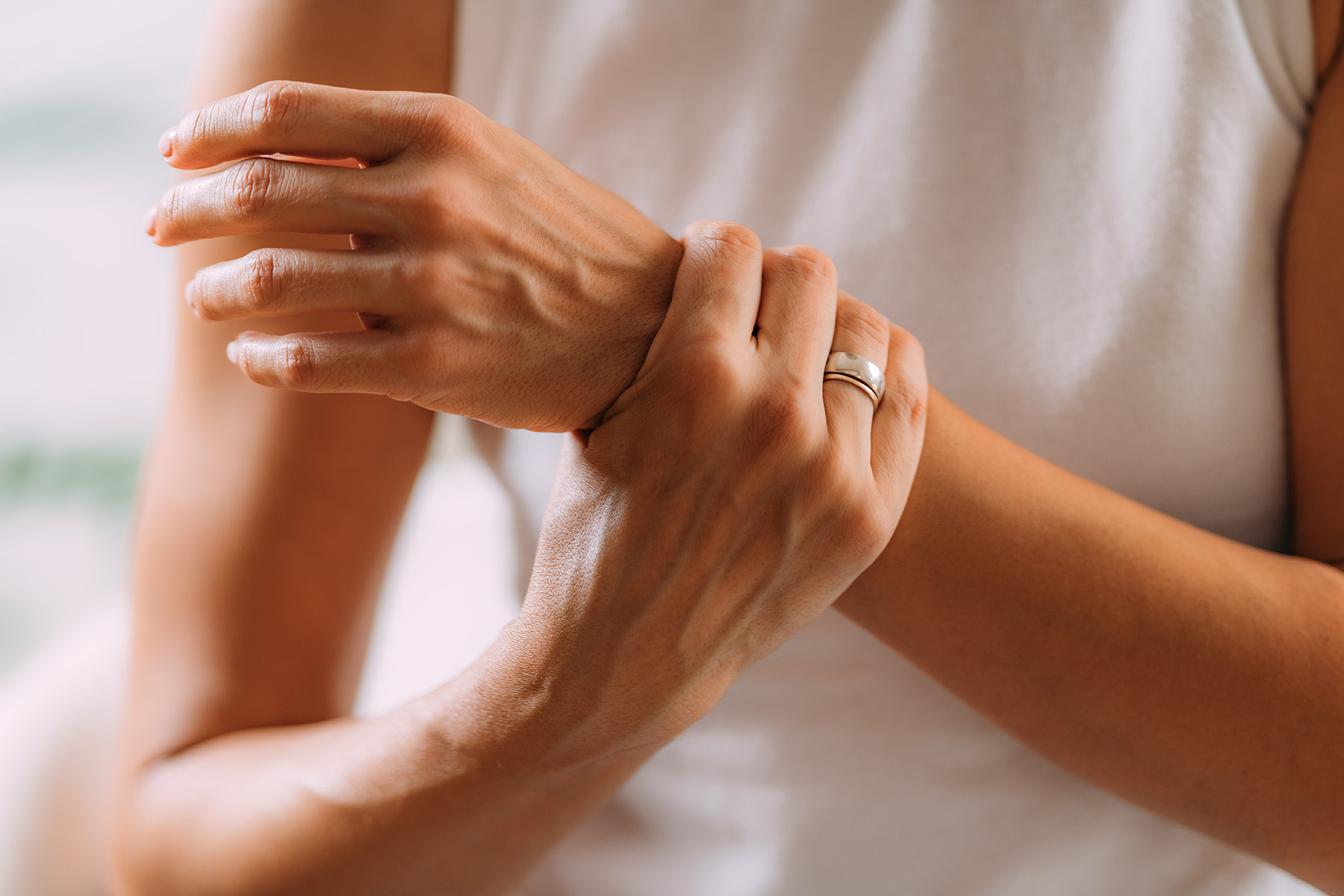 a woman grabbing her wrist