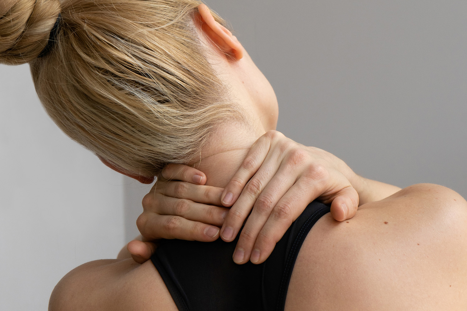 a woman rubbing her neck