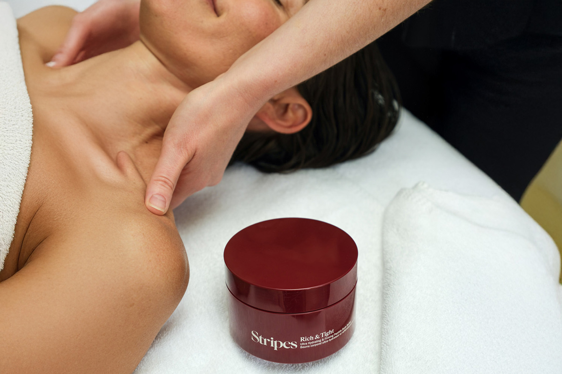a woman getting a massage with stripes beauty products at Canyon Ranch