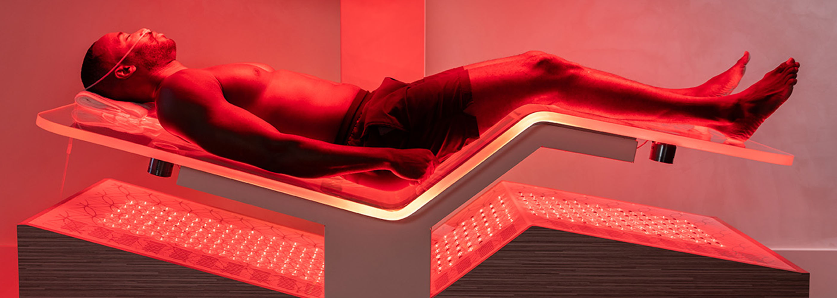 Man Laying in the Ammortal Chamber with Red Light