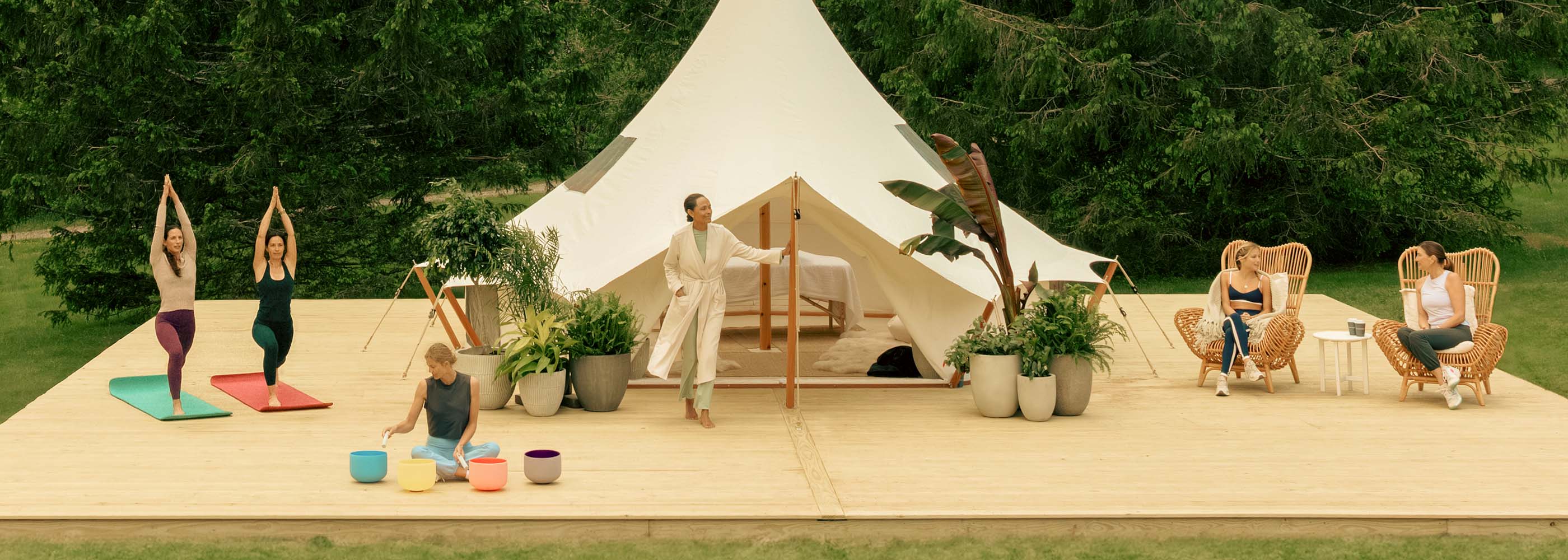 Display of Women Doing Yoga, Sound Bath and Meditation in front of the Tent