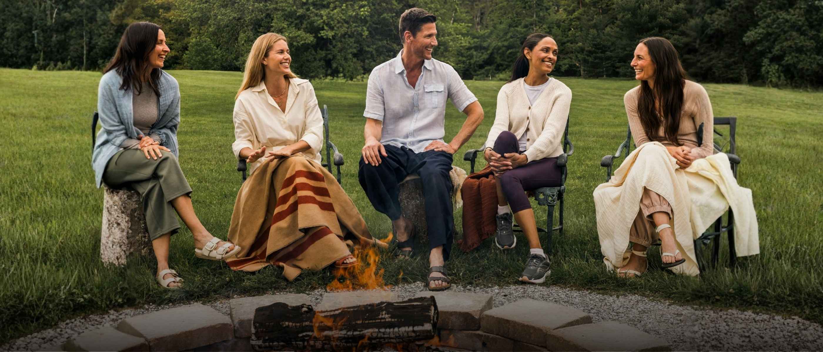 A group of adults around a firepit
