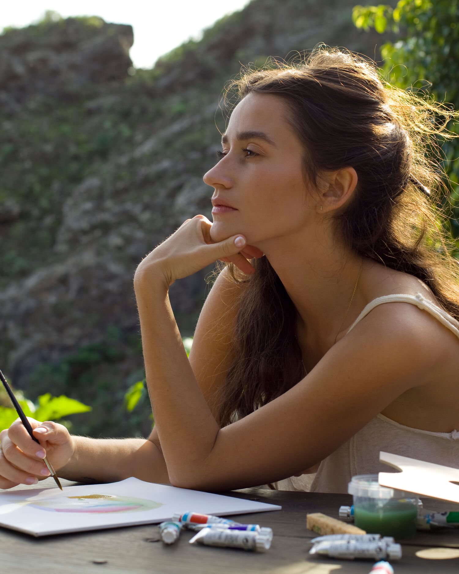 A woman painting outdoors