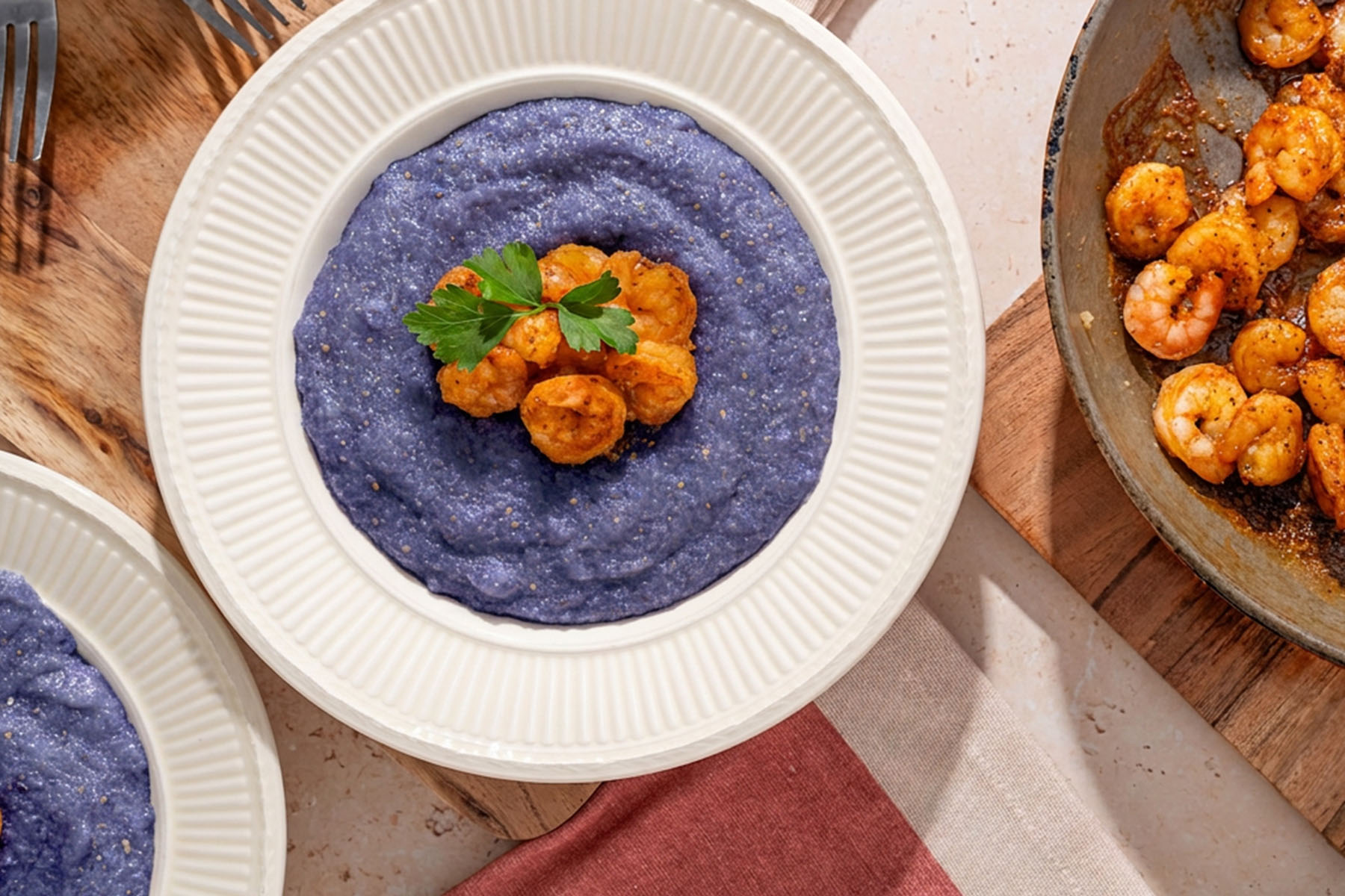 a bowl of grits with shrimp on top