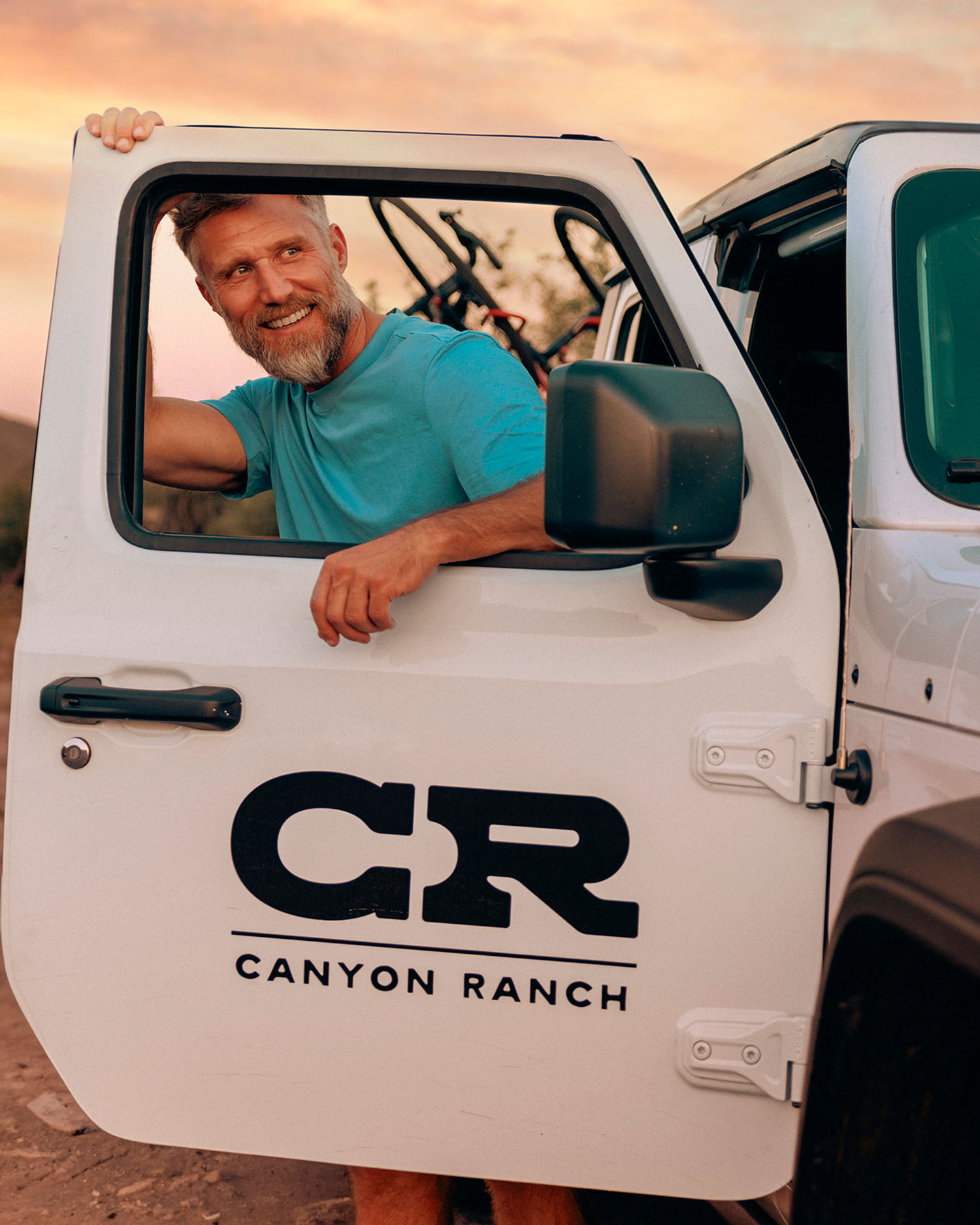 A man getting out of a jeep at Canyon Ranch