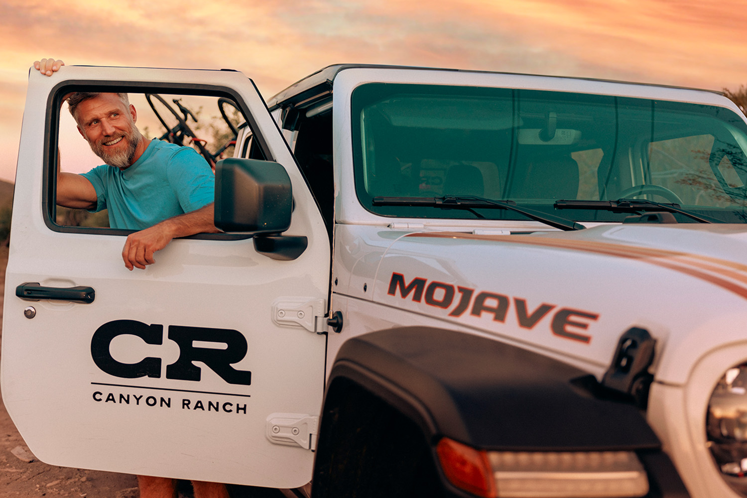 A man getting out of a jeep at Canyon Ranch