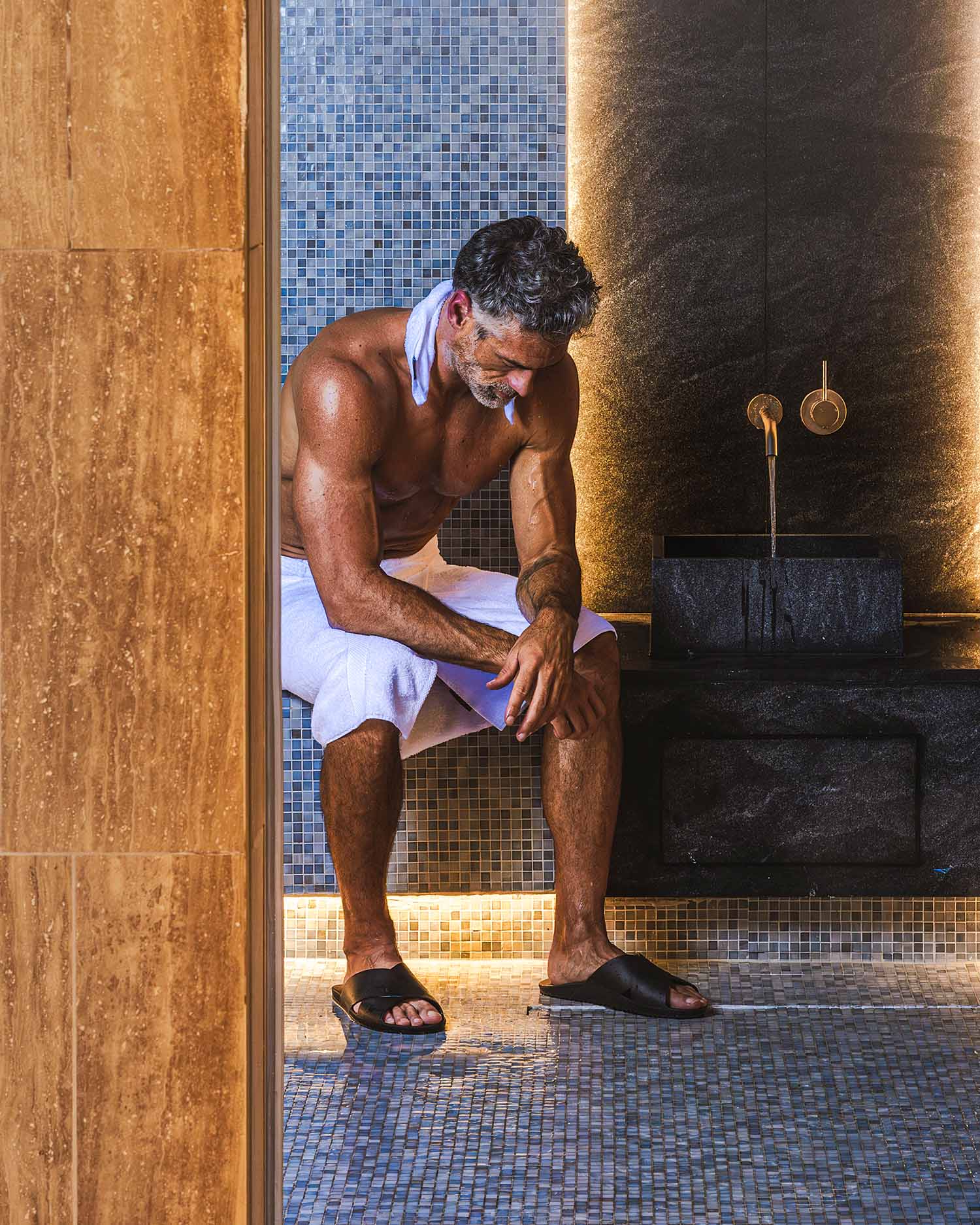 Man in Steam Sauna at Canyon Ranch Fort Worth Wellness club + Spa