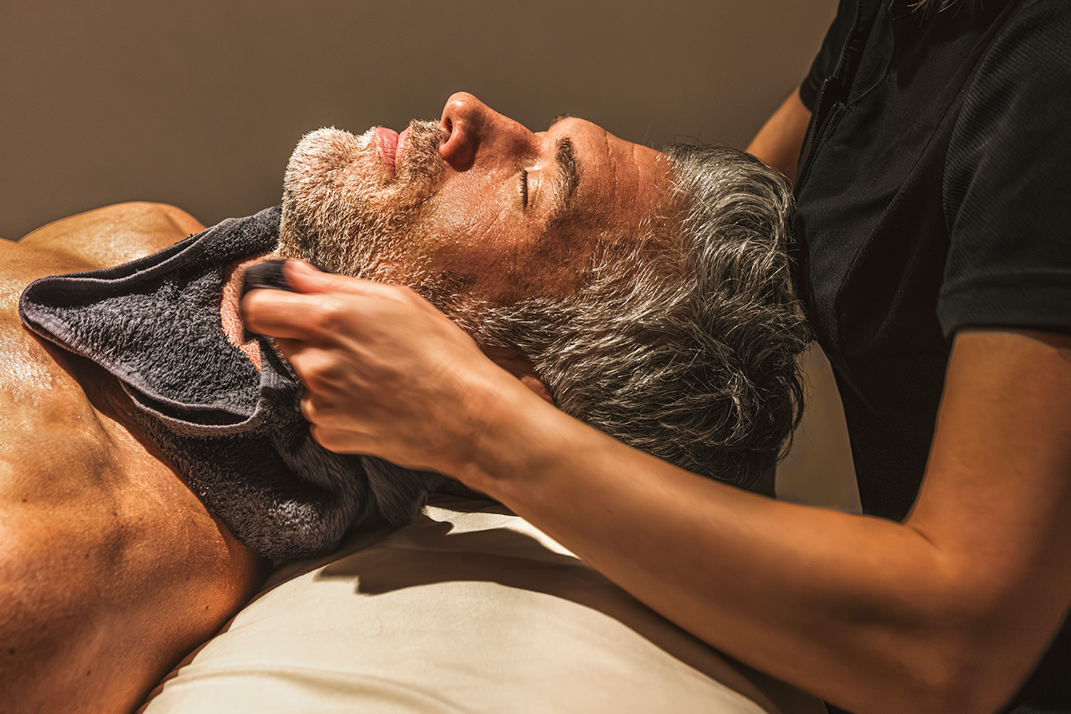 Man Receiving a Hot Towel Facial 