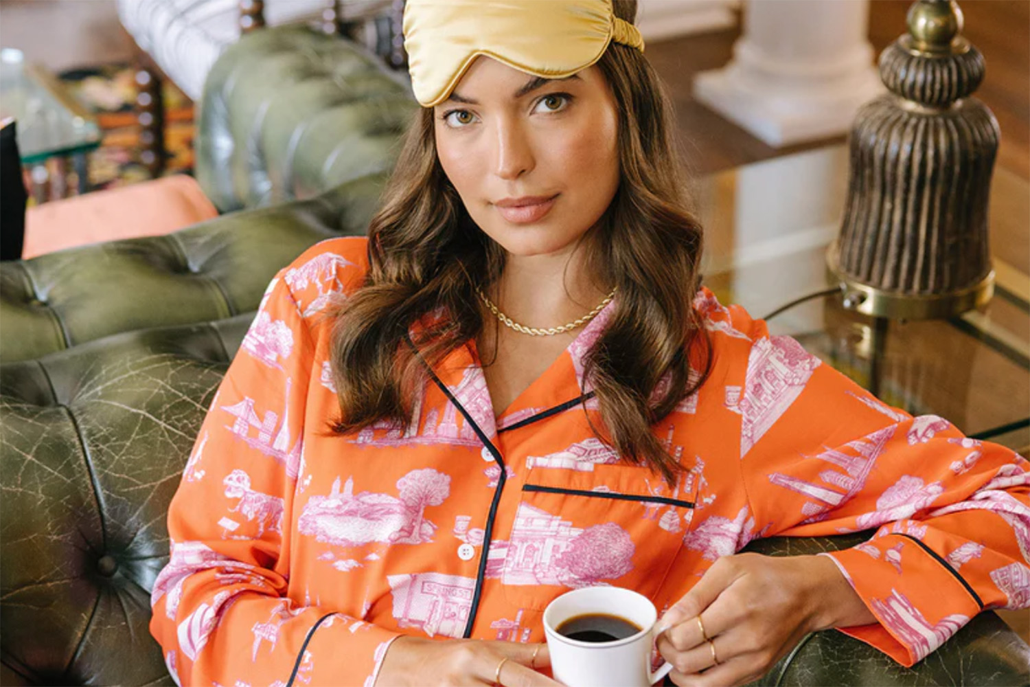 Katie Kime in Pajamas with a cup of coffee in hand