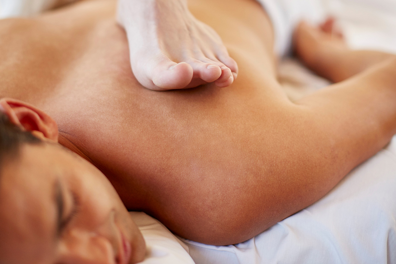 a man getting a ashiatsu massage