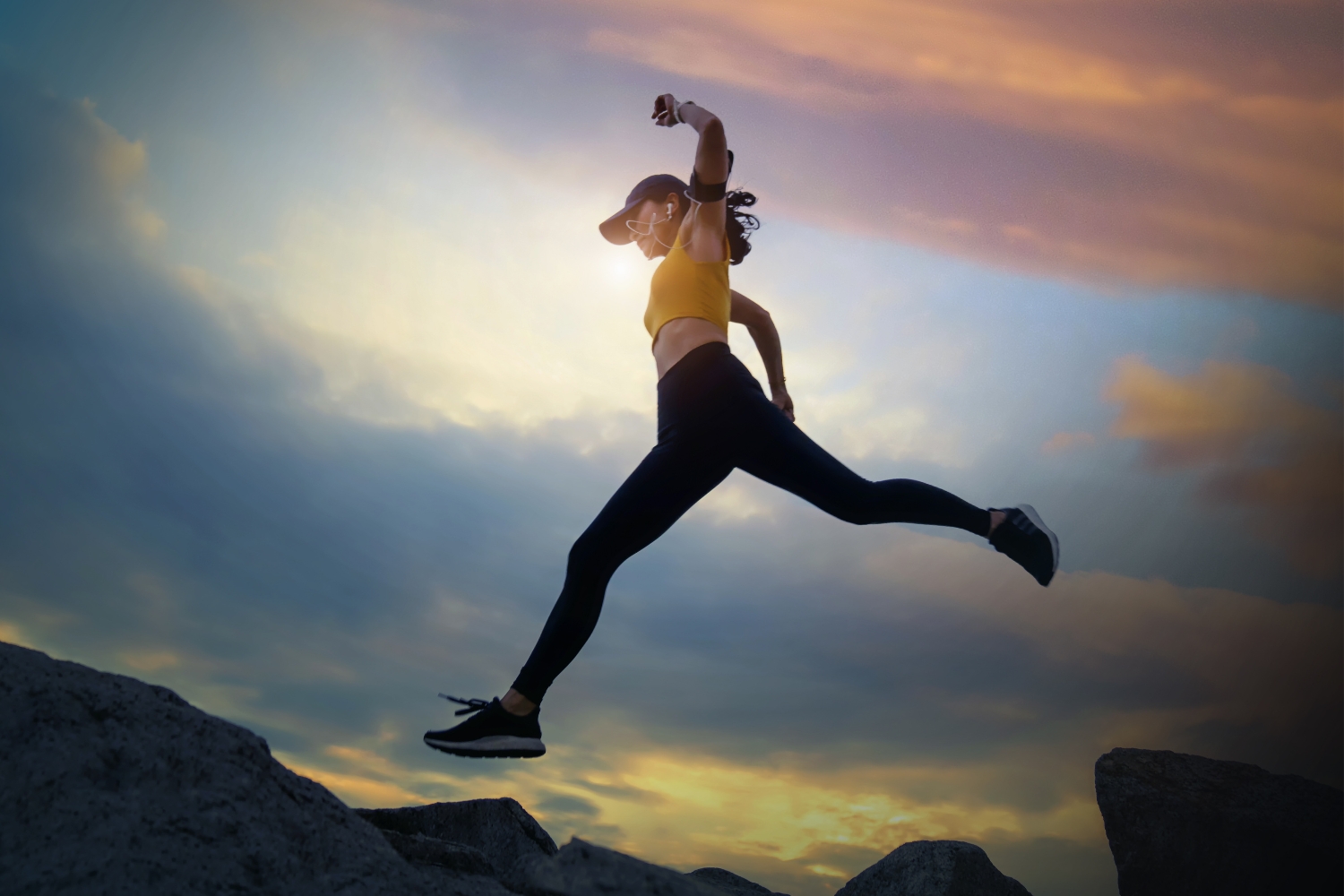 a woman jumping over a canyon