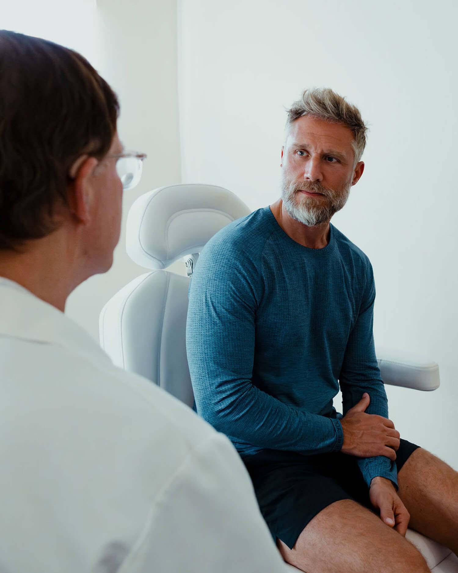 a man talking to a doctor