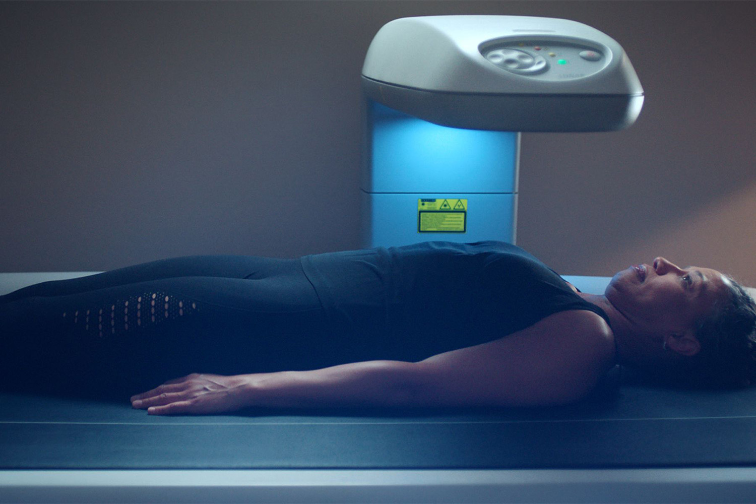 a woman in a dexa body scanner