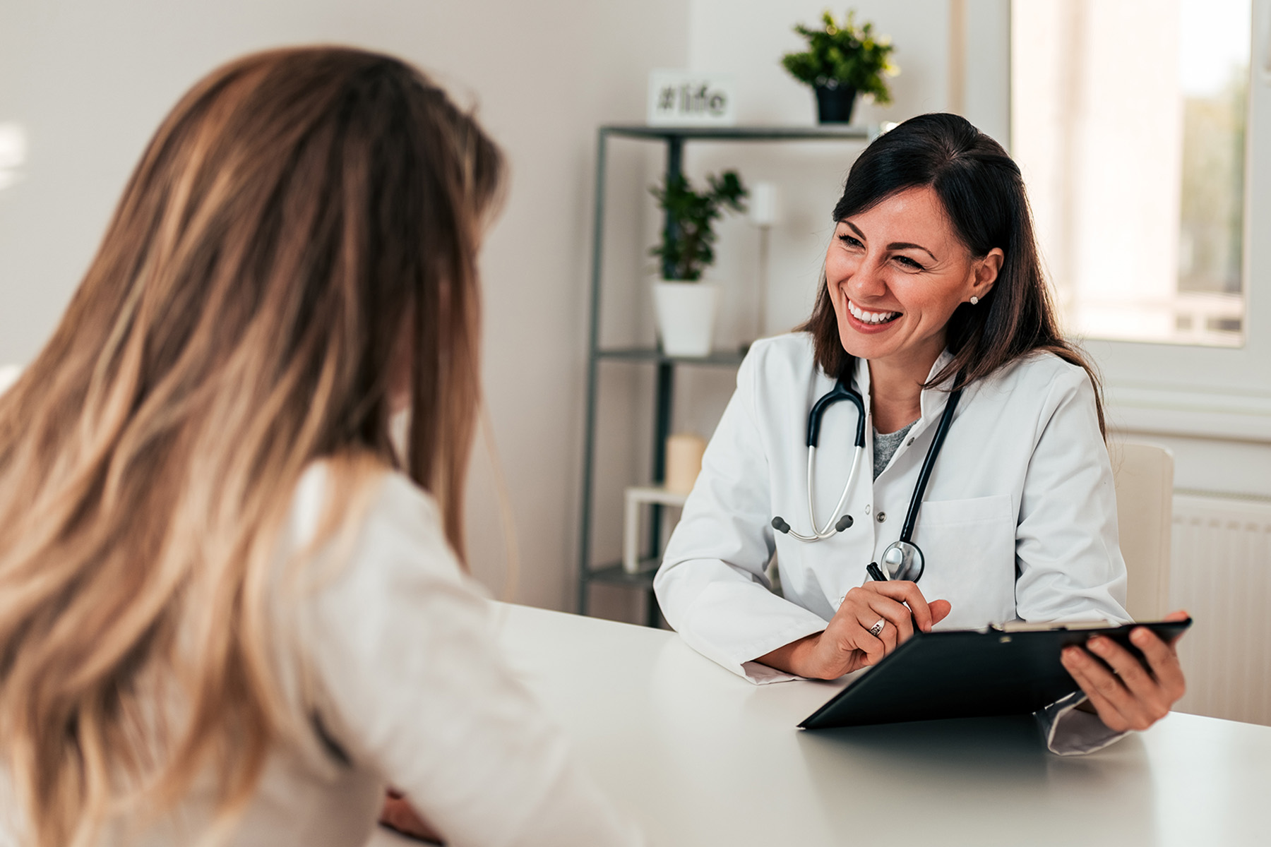 Woman During a Conversation with a Women's Health Physician  