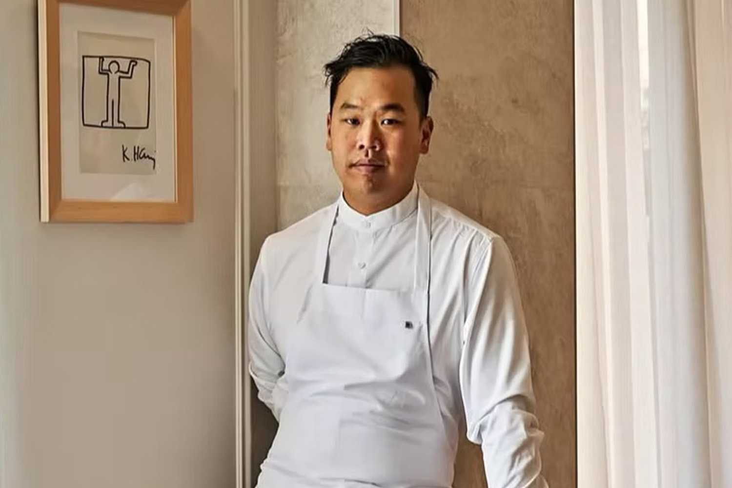 Photo of Chef Buddha Lo Standing in a Restaurant With His Uniform 