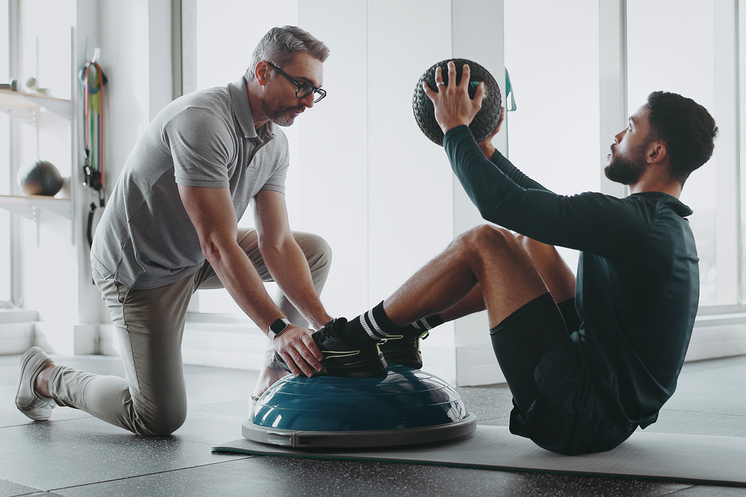 Man Training With Personal Trainer