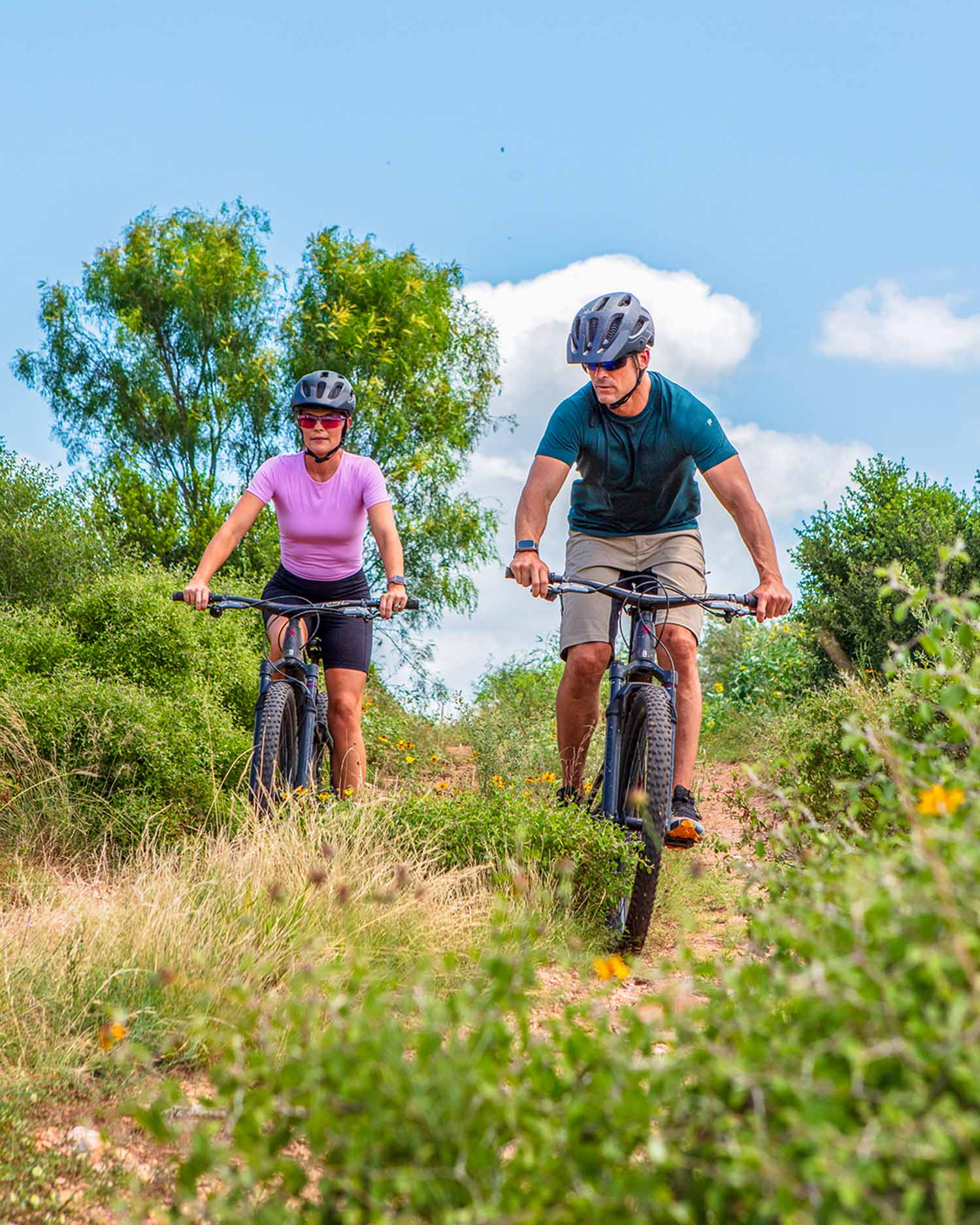 A man and woman riding bikes