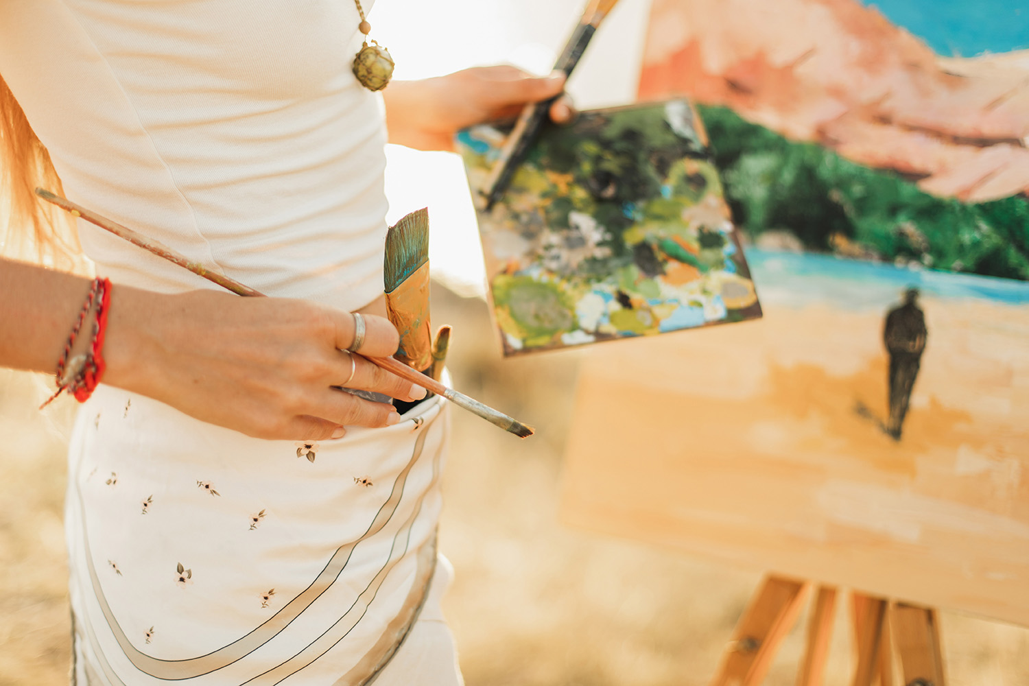 Woman Painting a Desert Landscape