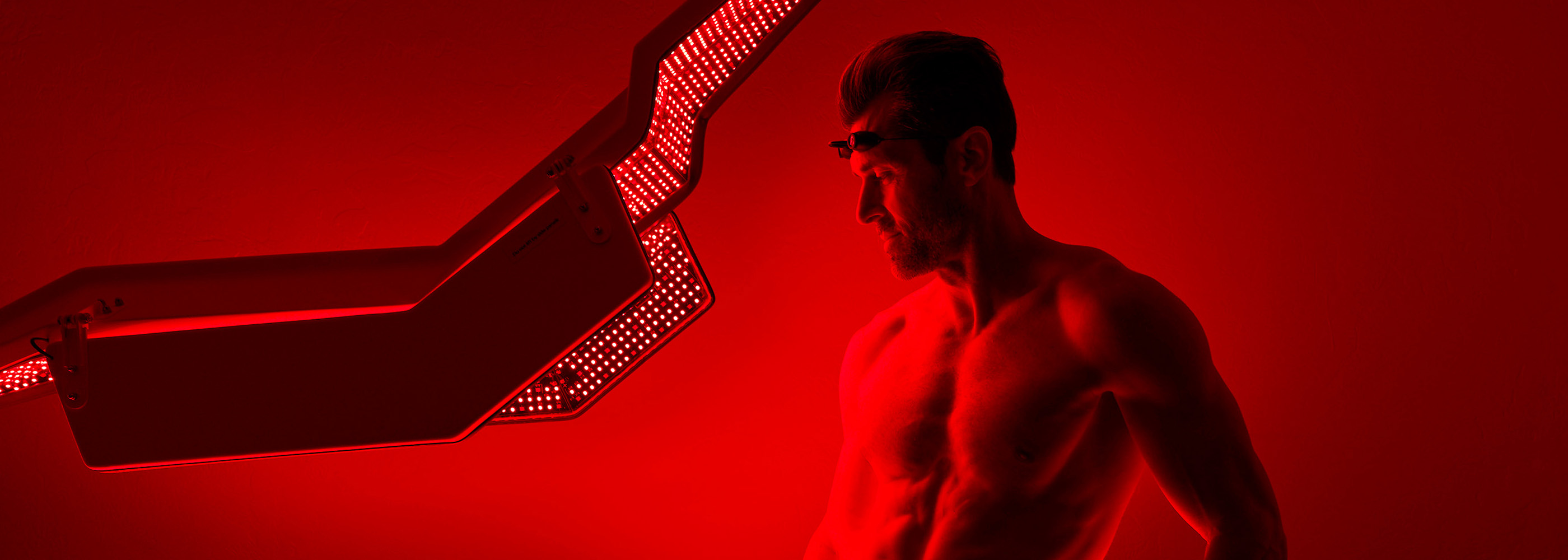 Man Laying Inside Red Light Bed 