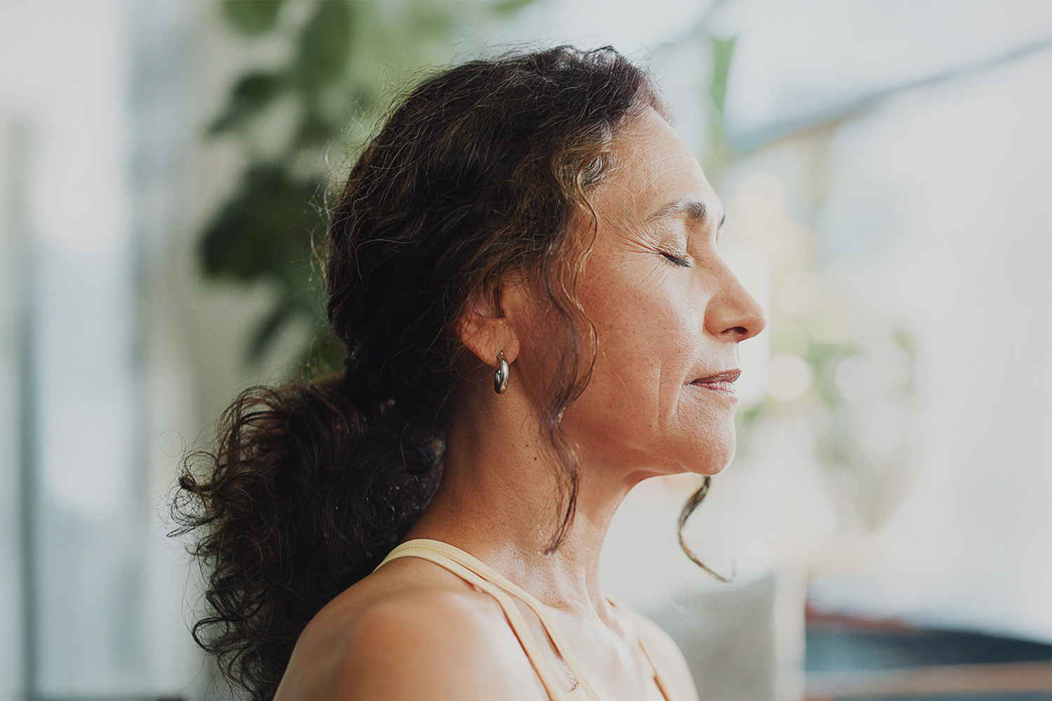 Woman Meditating in Front of a Window 
