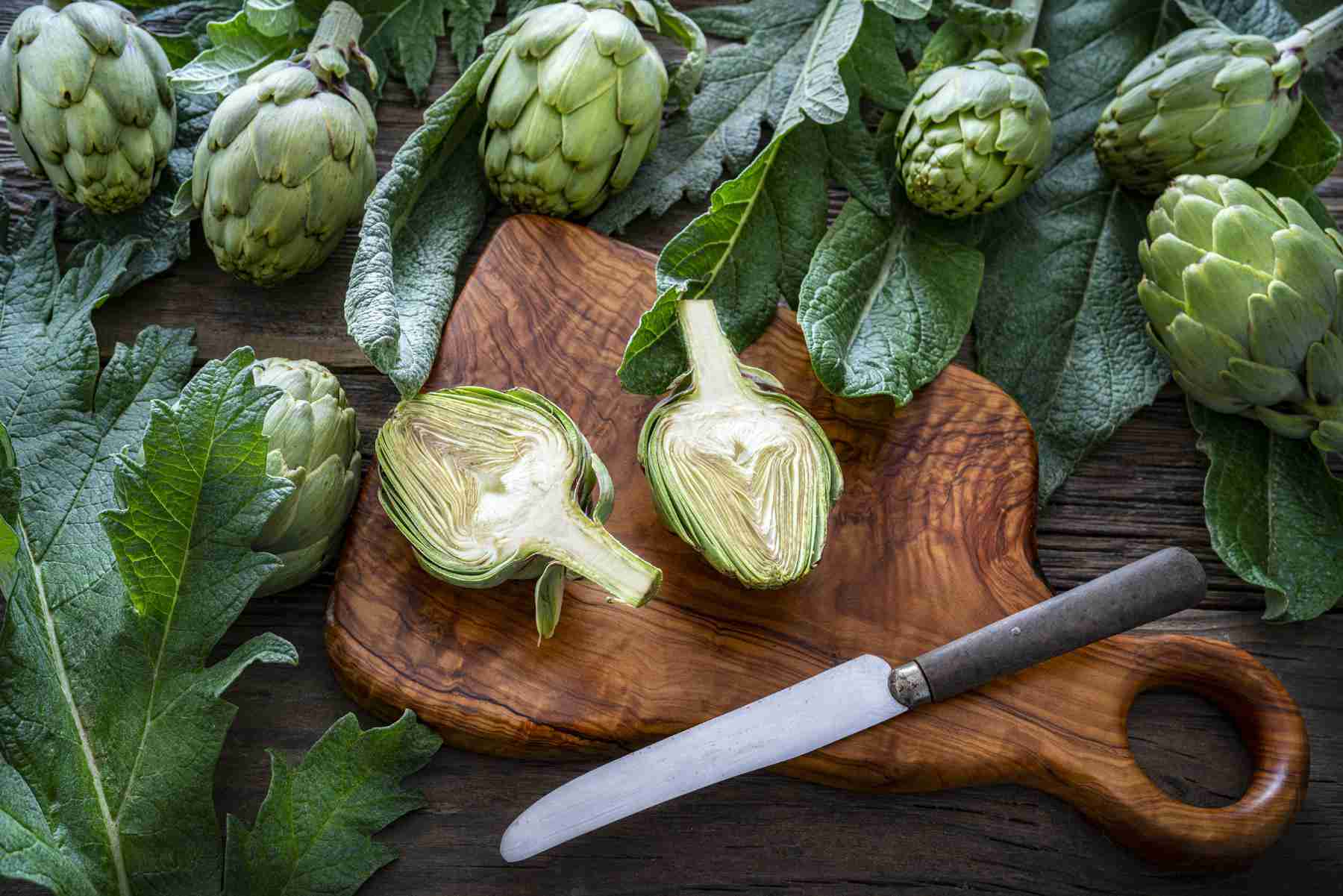 artichoke heads on a chopping board