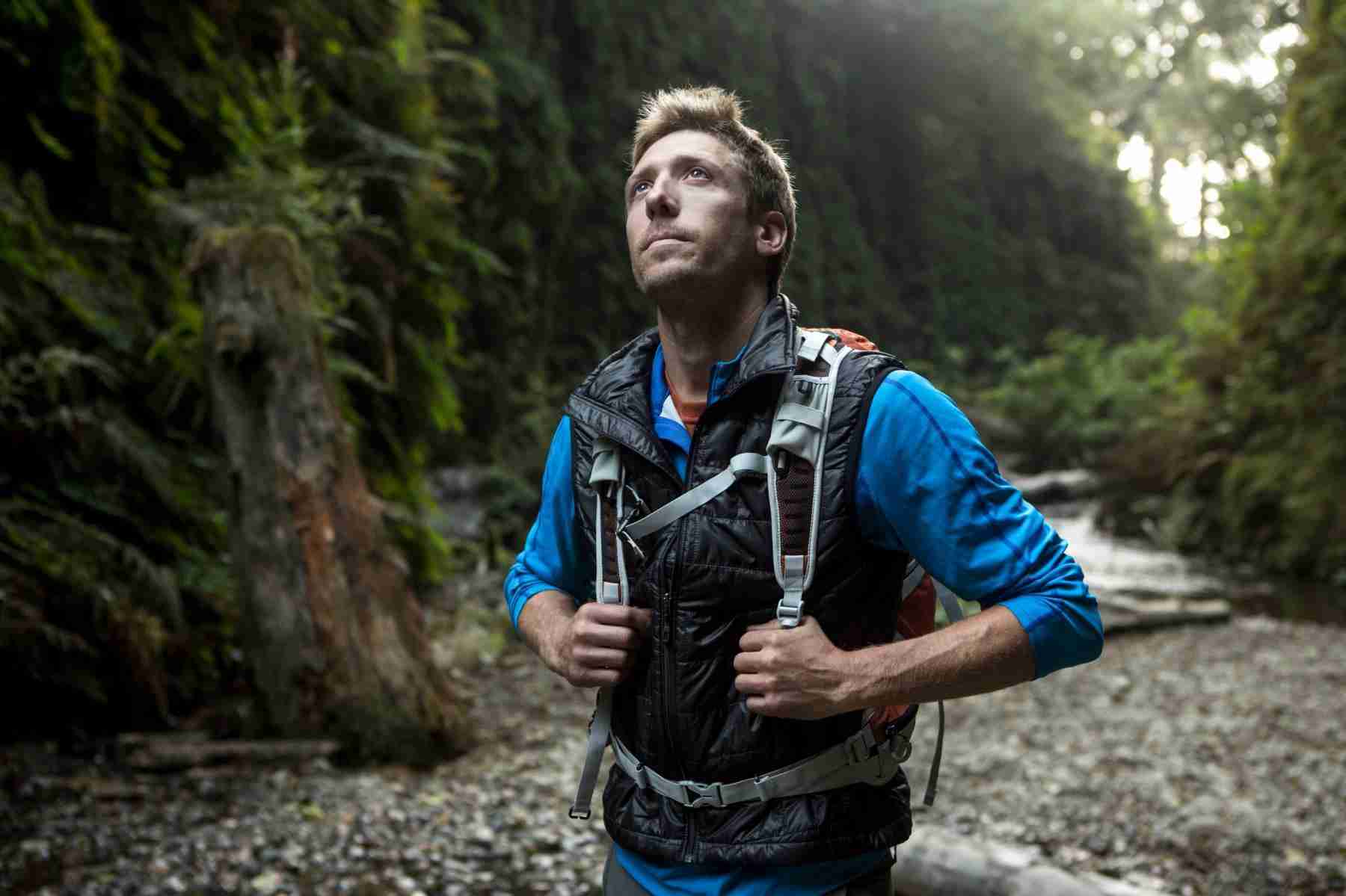 A man with a hiking backpack in the forest