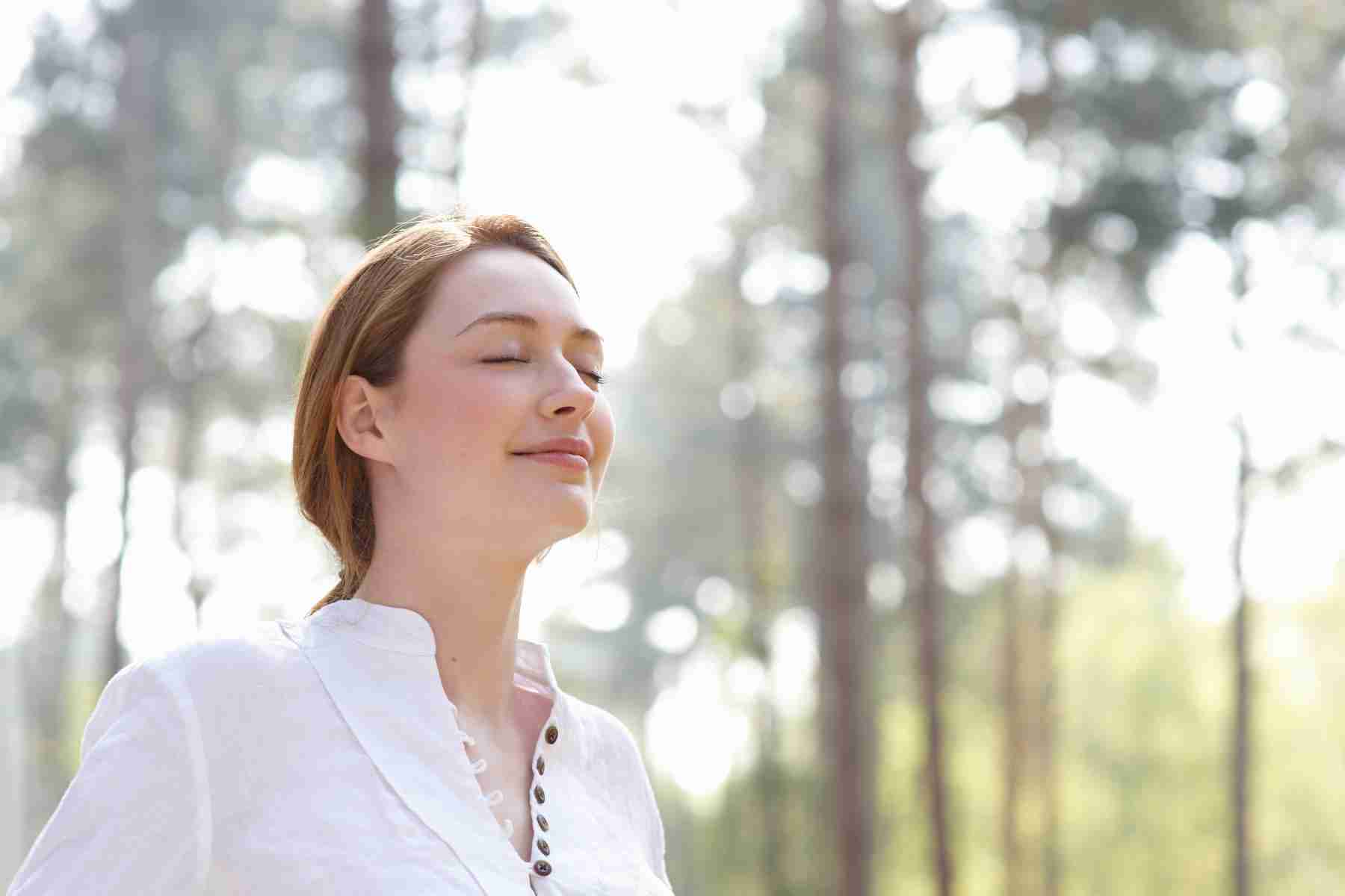 Close-up of man sitting on couch leaning back with eyes closed.