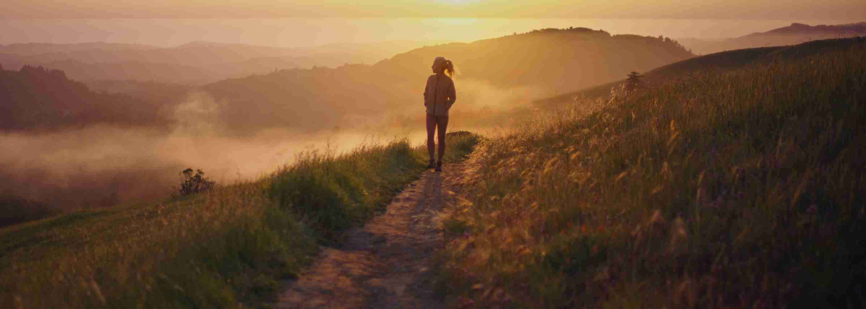 A woman walking on a trail