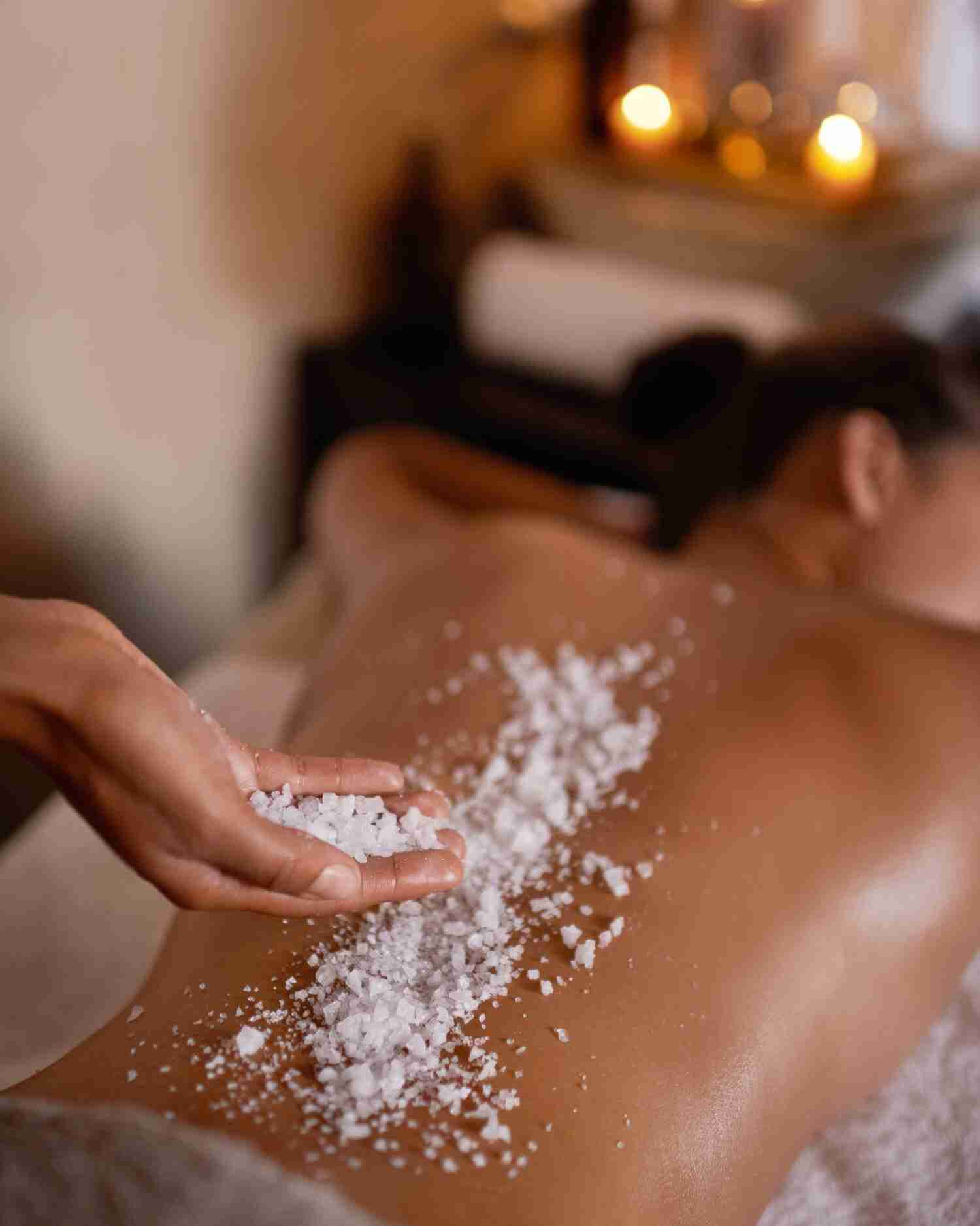 A woman getting a salt body scrub