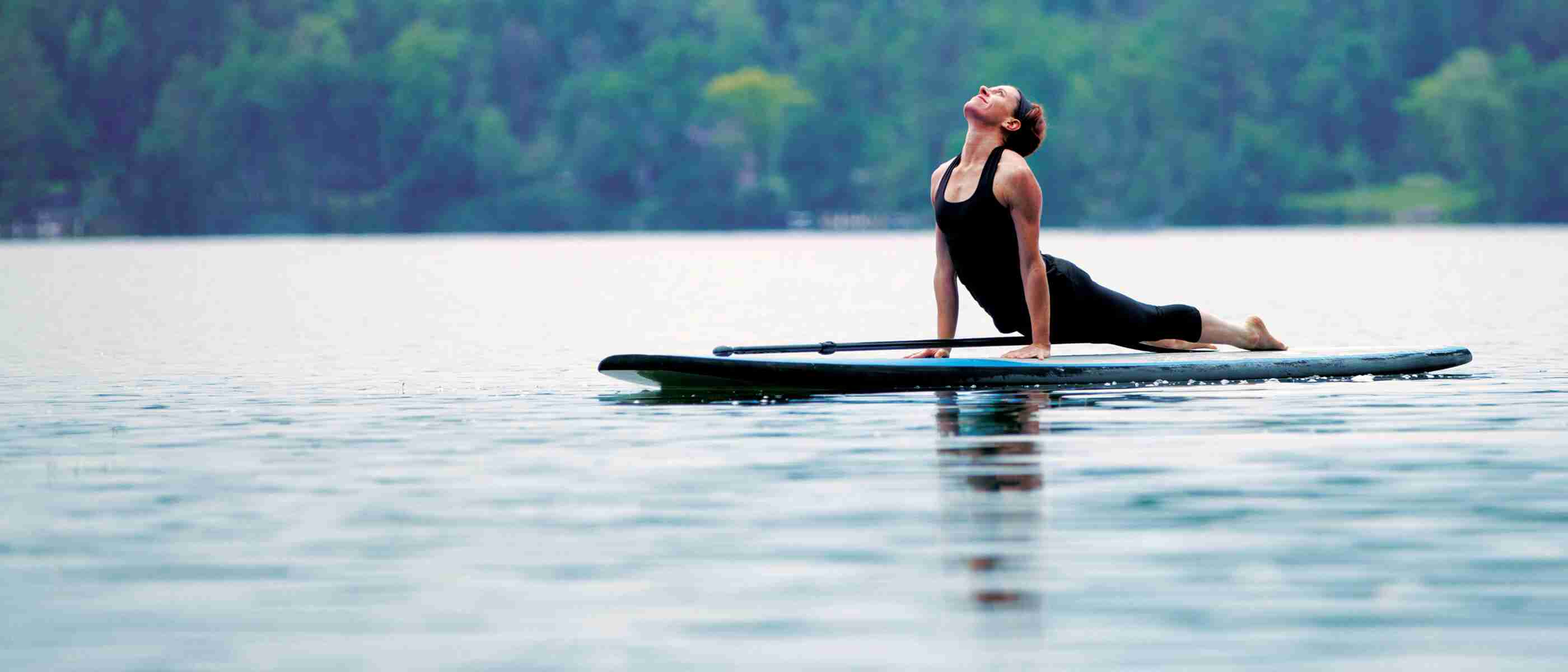 A woman doing yoga on a paddleboard