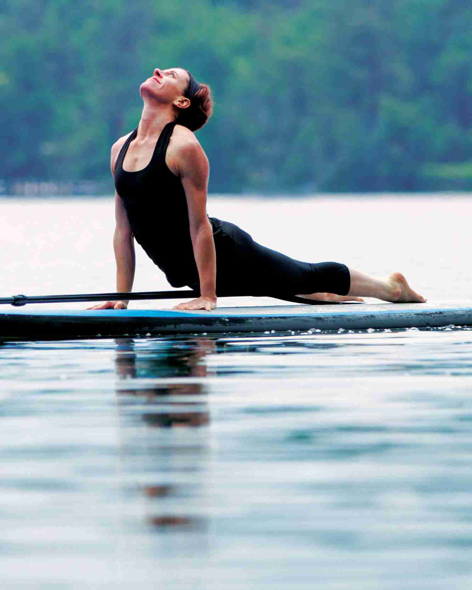 A woman doing yoga on a paddleboard