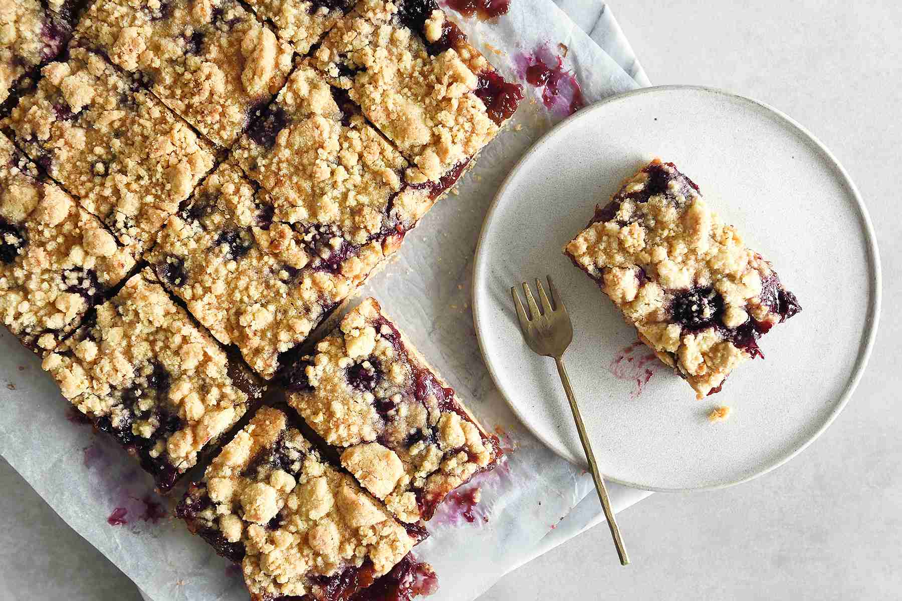 a baking sheet and plate of blueberry oat bars