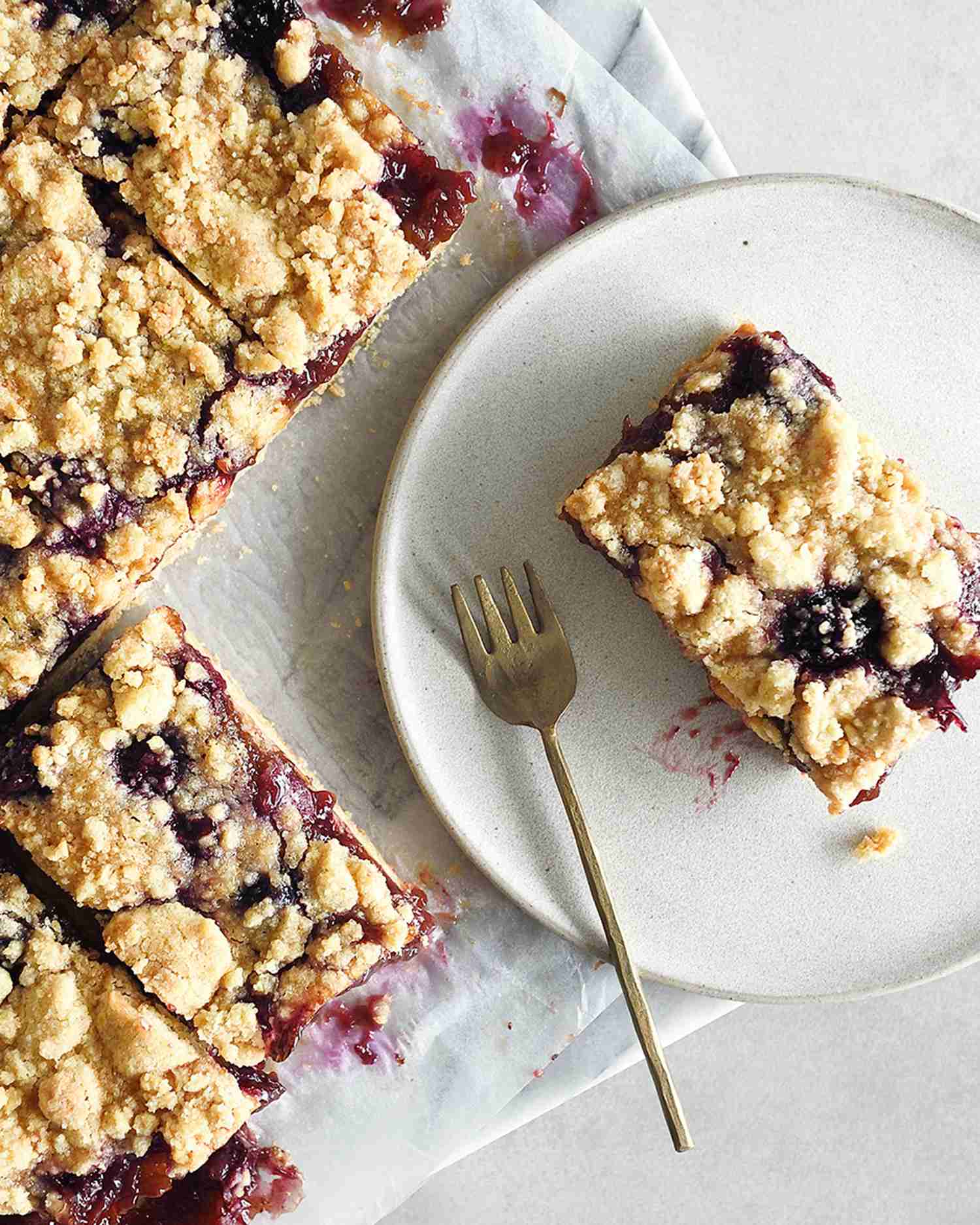 a baking sheet and plate of blueberry oat bars