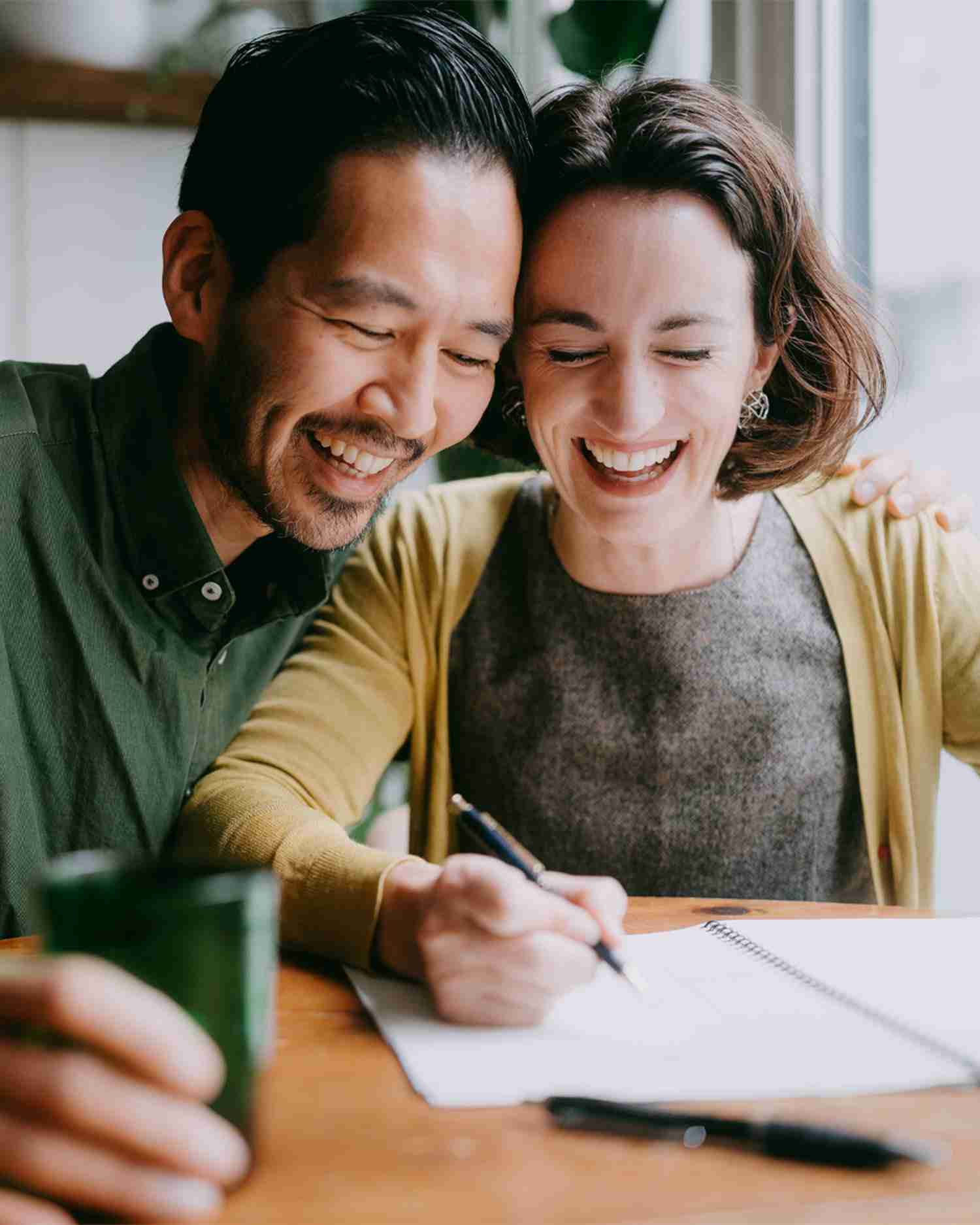 a couple doing finances happily