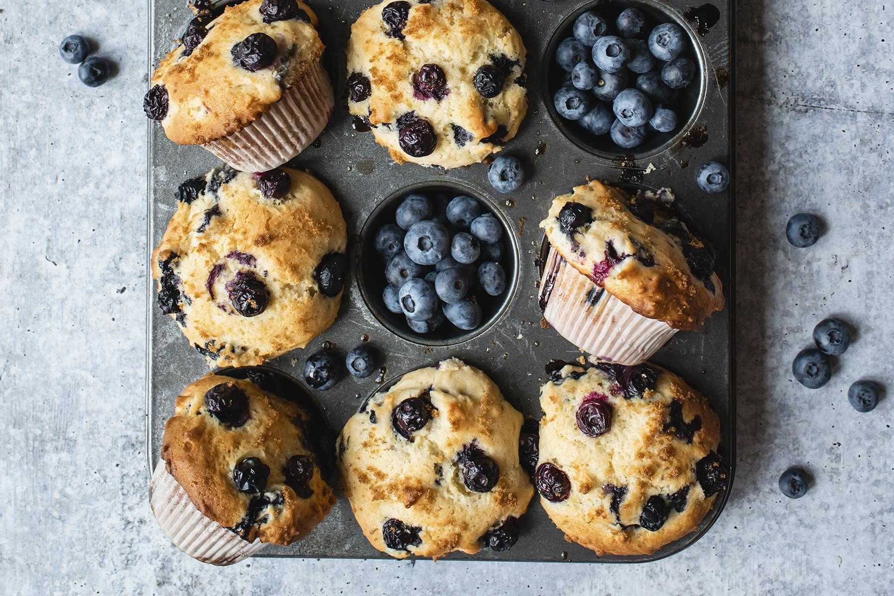 Cooked blueberry muffins in muffin pan.