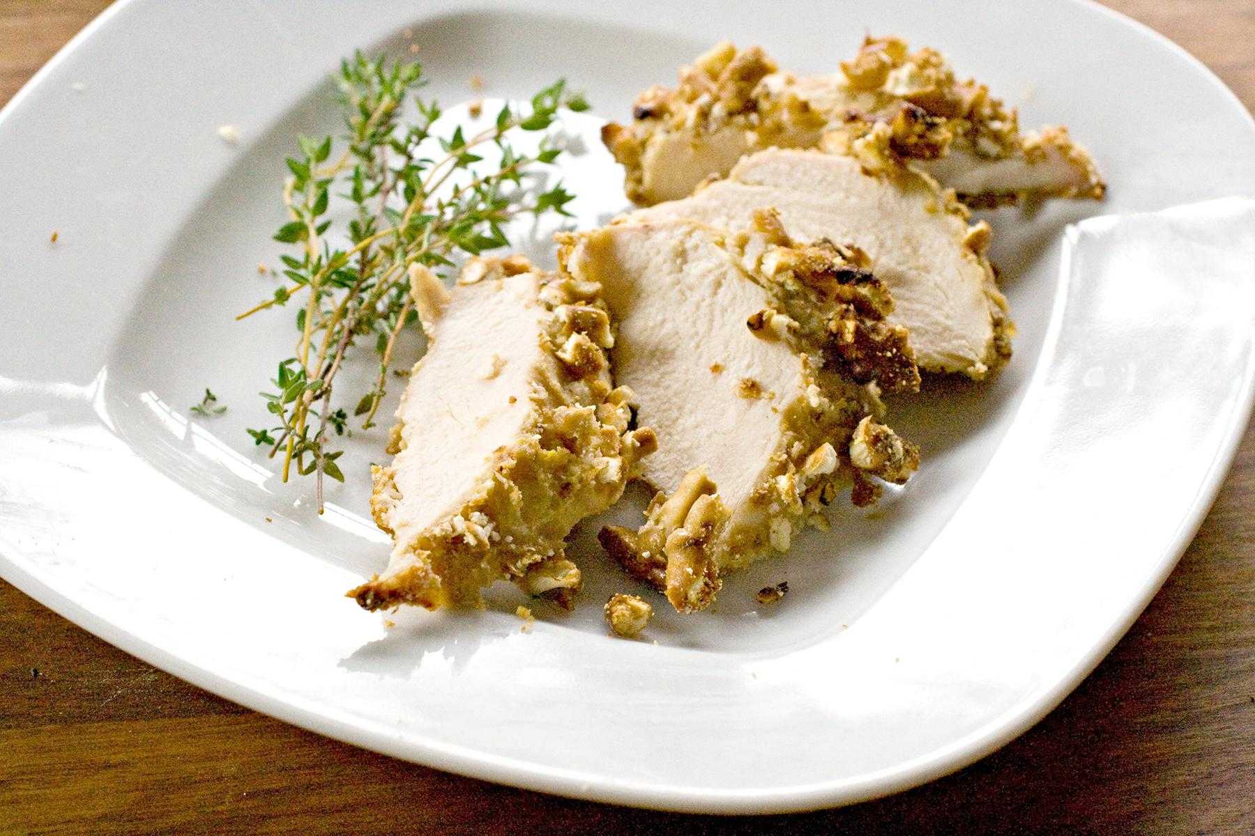 Pecan crusted chicken on a white plate.