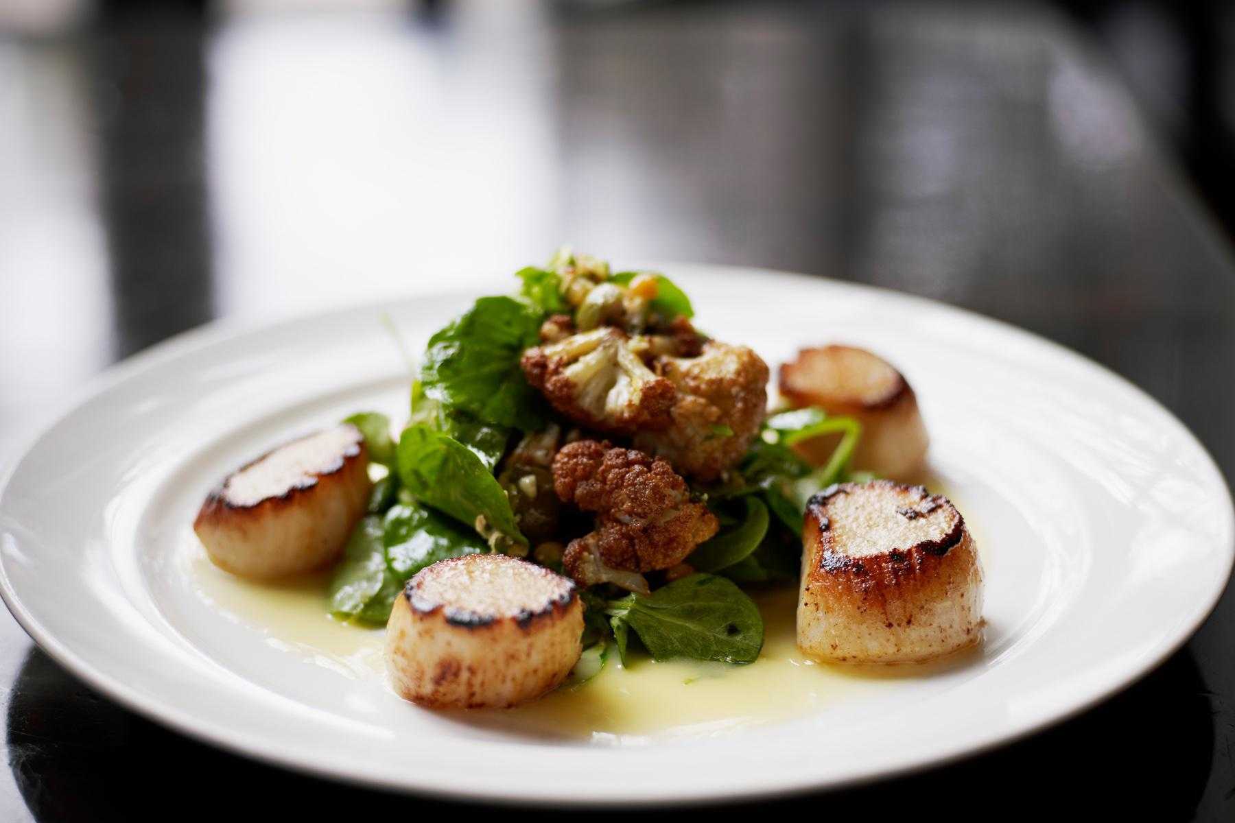 Plate with seared scallops.