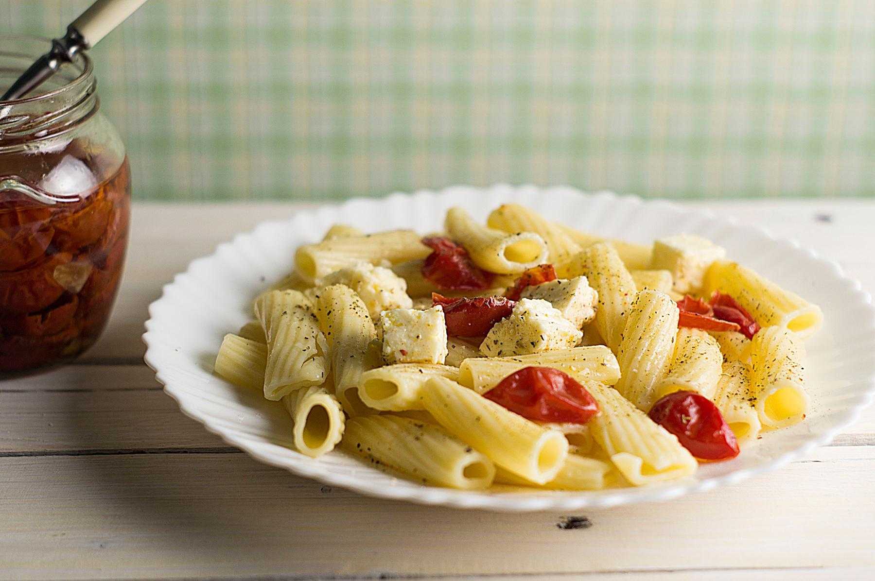 A bowl of sun-dried tomato pasta with feta cheese.