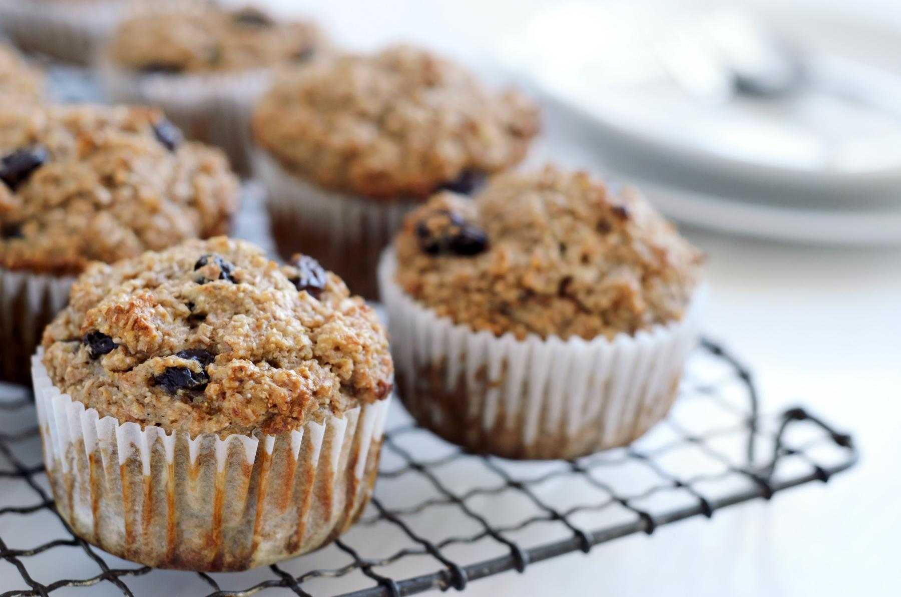 Close-up of bran muffins cooling off on baking rack.