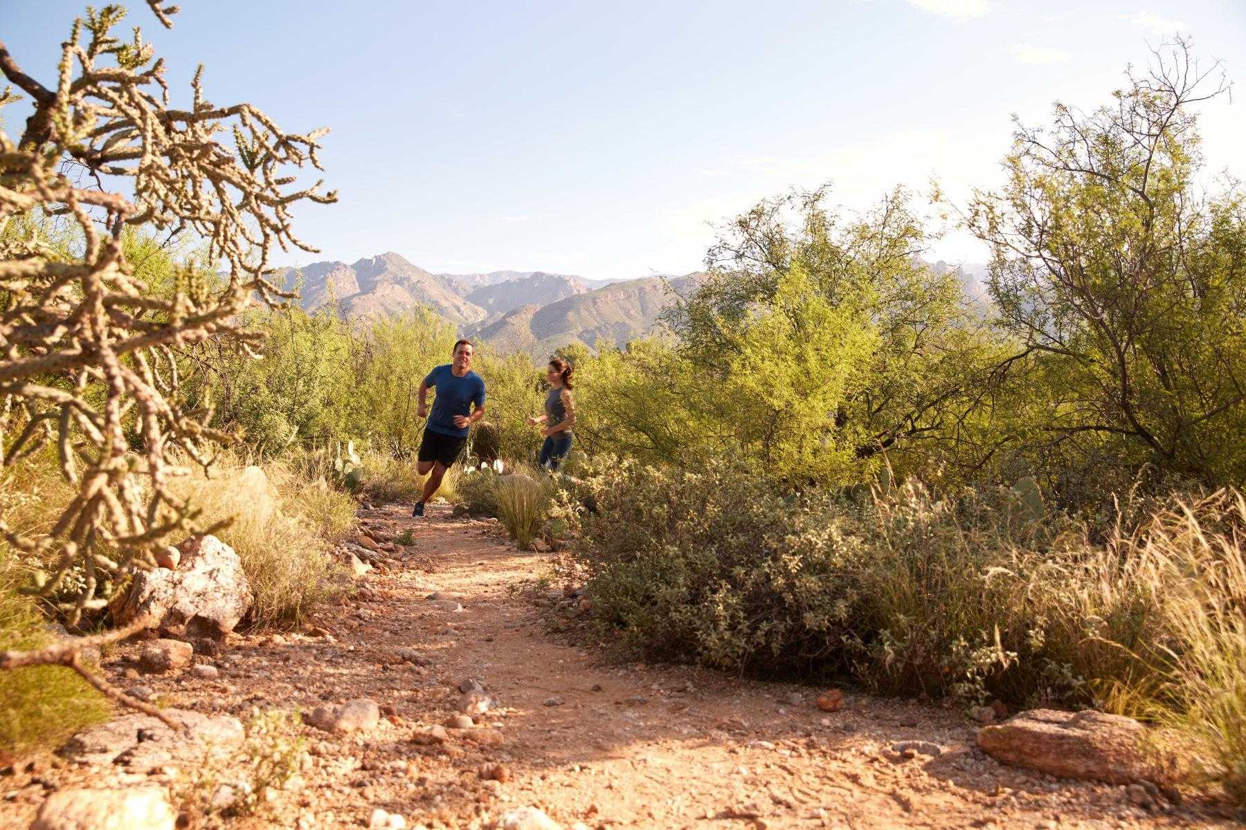 couple running through Sonoran Desert